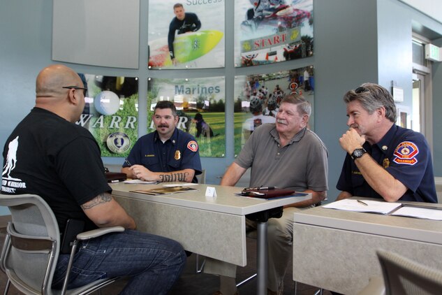 Sgt. Ramond Rivera, a wounded warrior with WWBn.-West, Camp Pendleton speaks with representatives of Camp Pendleton Fire Department during Headquarters Marine Corps Hiring Heroes career seminar, April 24 on Camp Pendleton. The goal of the Marine Corps WWBn. Internship Program is to aid wounded warriors in transition from the military lifestyle to excelling in the civilian workforce.