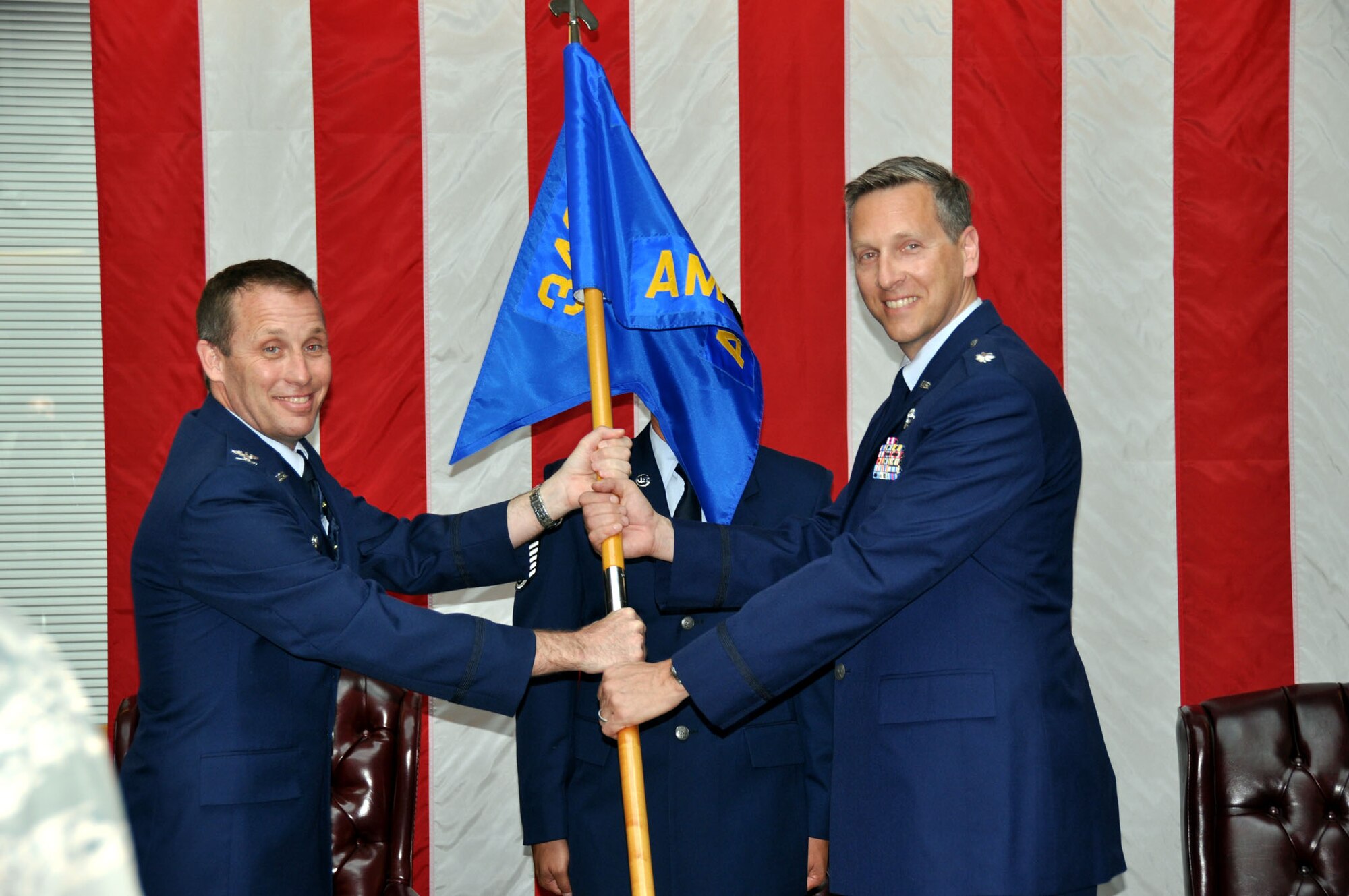 TRAVIS AIR FORCE BASE, Calif. -- Col. Matthew J. Burger, 349th Operations Group commander (left), passes the flag of the 349th Air Mobility Operations Squadron to Lt. Col. Paul Hromanik, in a change of command ceremony here April 22. The ceremony was well attended by members of Team Travis. The change of command ceremony is a time-honored tradition which formally symbolizes the continuity of authority as the command is passed from one officer to another. (U.S. Air Force photo / Capt. Robin Jackson)