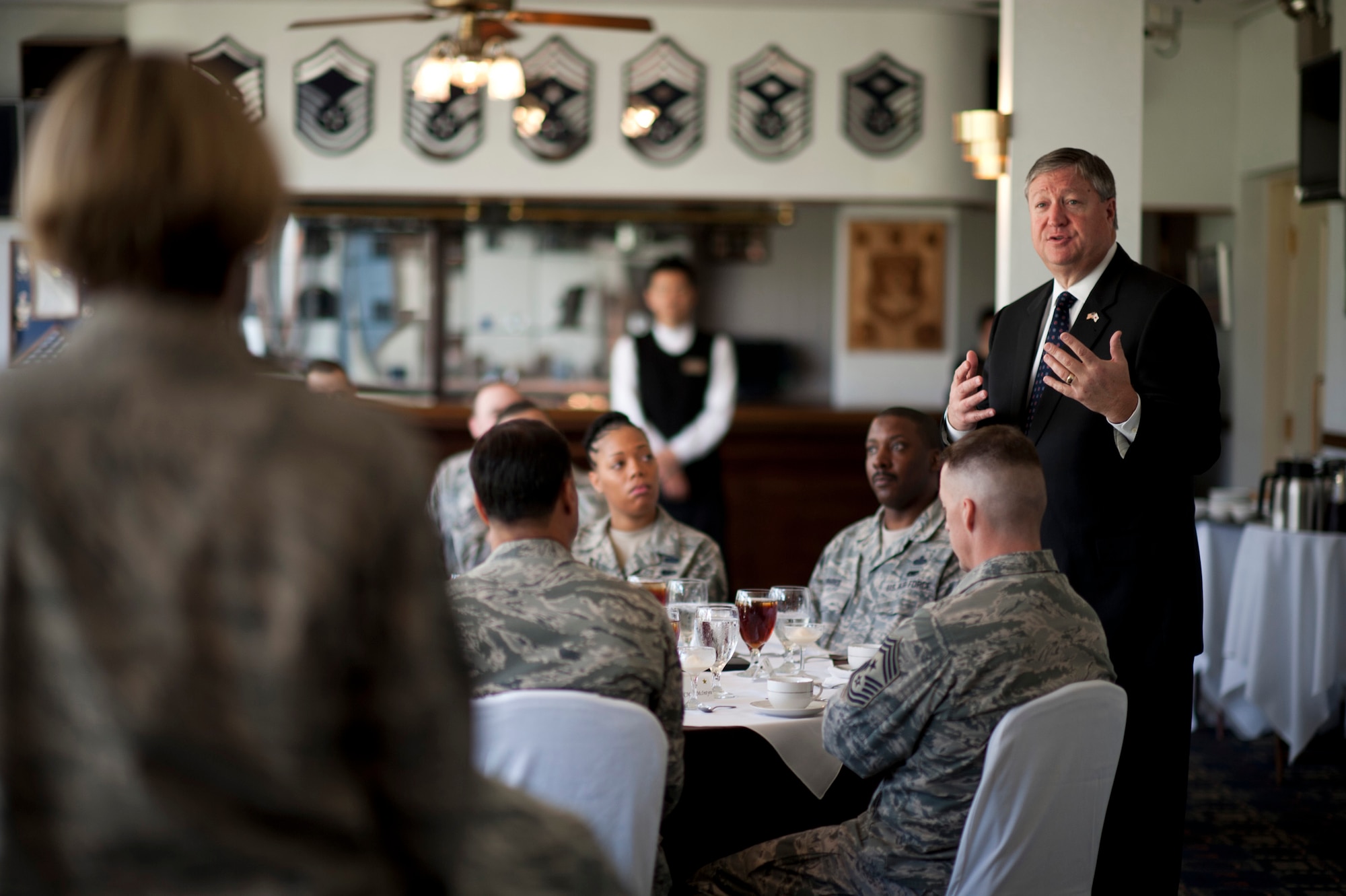 Secretary of the Air Force Michael Donley (right) answers a question from Senior Master Sgt. Jodi Hayes (left), 5th Air Force Legal office, during a luncheon at Yokota Air Base, Japan, April 24, 2012.  During his visit to the base, the secretary toured various facilities throughout the 374th Airlift Wing, 5th Air Force, U.S. Forces, Japan and the Japan Air Self-Defense Force Air Defense Command Headquarters.  (U.S. Air Force photo/Staff Sgt. Samuel Morse)