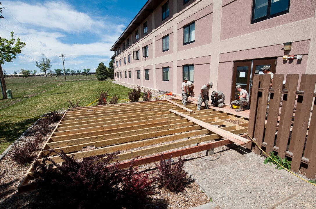 Members of the 28th Civil Engineer Squadron structures section build a deck at the Pine Tree Inn on Ellsworth Air Force Base, S.D., April 24, 2012. The 28th Civil Engineer Squadron is responsible for the structural maintenance of 328 buildings on and off base and ensuring the safety and reliability of these facilities. (U.S. Air Force photo by Airman 1st Class Alystria Maurer/Released)