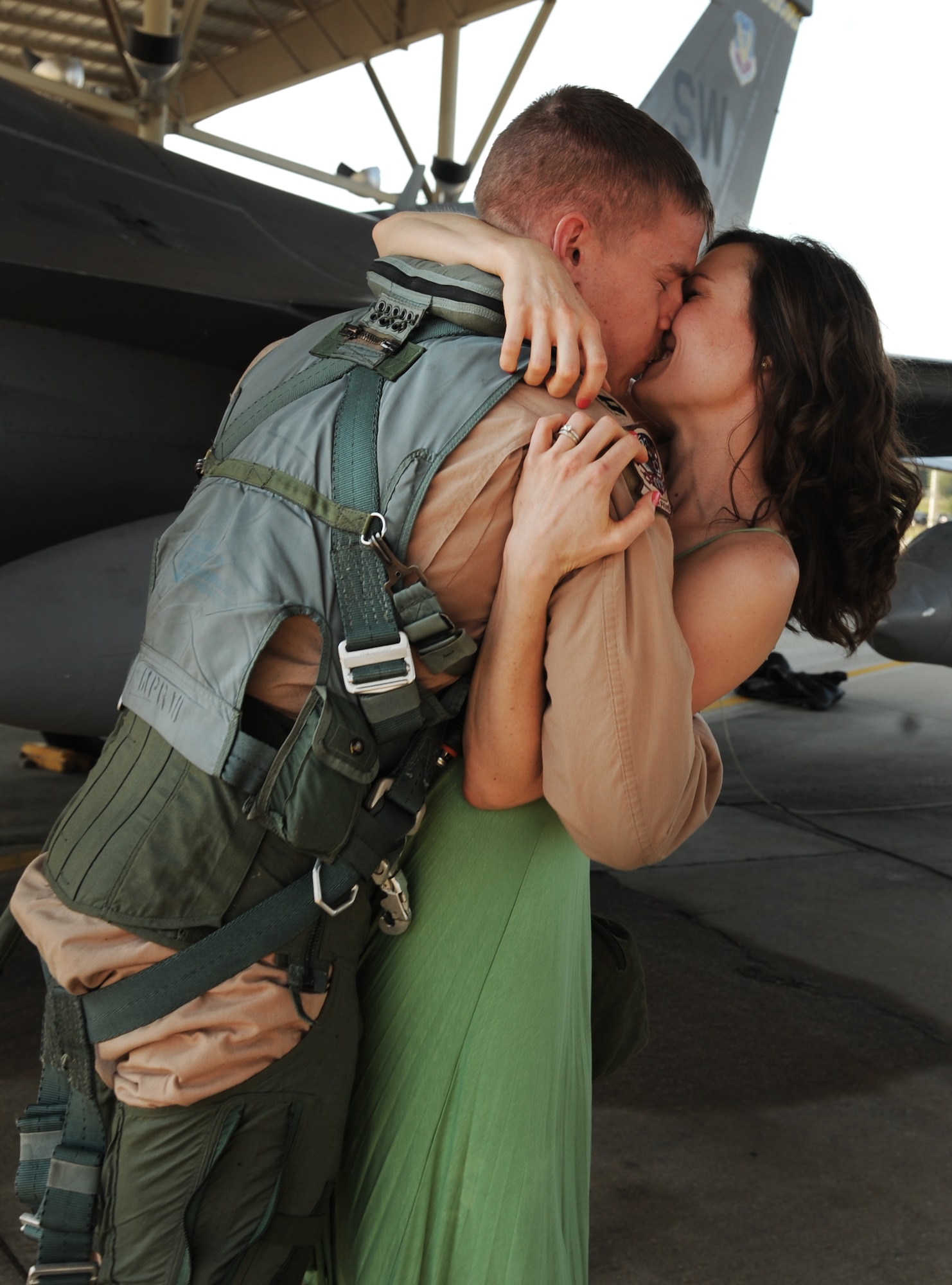 U.S. Air Force Capt. Jason Piper, 79th Fighter Squadron F-16 Fighting Falcon pilot, embraces his wife Courtney Piper after returning home to Shaw Air Force Base, S.C., April 25, 2012. 79th Fighter Squadron returns home after a seven month deployment to Iraq, where they provided top cover for the last convoys to leave Iraq. (U.S. Air Force photo by Senior Airman Tabatha McCarthy/released)