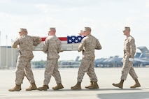 A U.S. Marine Corps carry team transfers the remains of Marine Staff Sgt. Joseph H. Fankhauser, of Mason, Texas, at Dover Air Force Base, Del., April 25, 2012. Fankhauser was assigned to 7th Engineer Support Battalion, 1st Marine Logistics Group, I Marine Expeditionary Force, Camp Pendleton, Calif. (U.S. Air Force photo/Roland Balik)