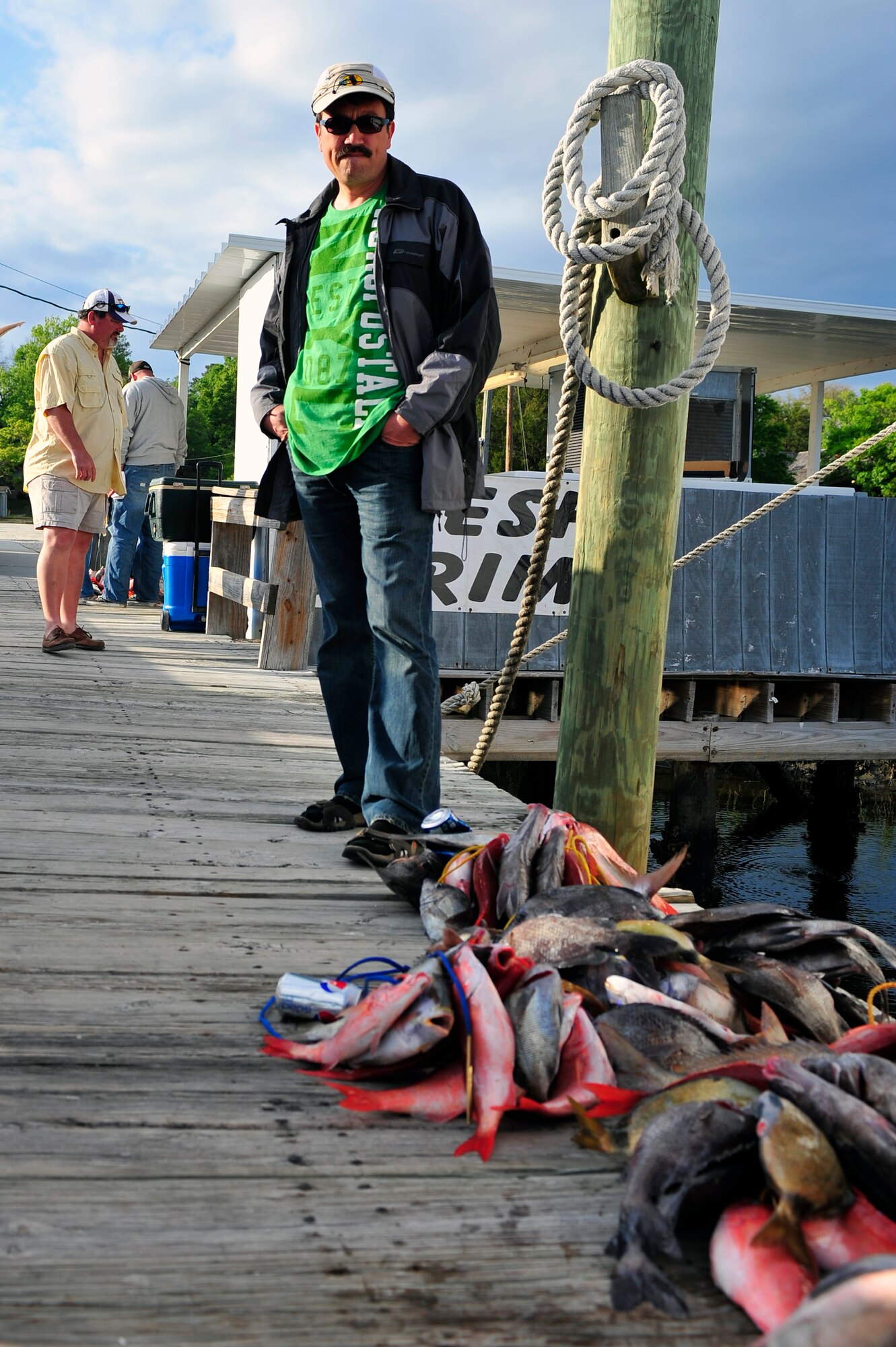 A fisherman stands by his catch at the end of a long day at sea at Calabash, N.C. April 14, 2012. Shaw’s outdoor recreation offers several deep sea fishing trips throughout the spring and summer that Department of Defense ID card holders can take advantage of. (U.S. Air Force photo by Senior Airman Daniel Phelps/Released)