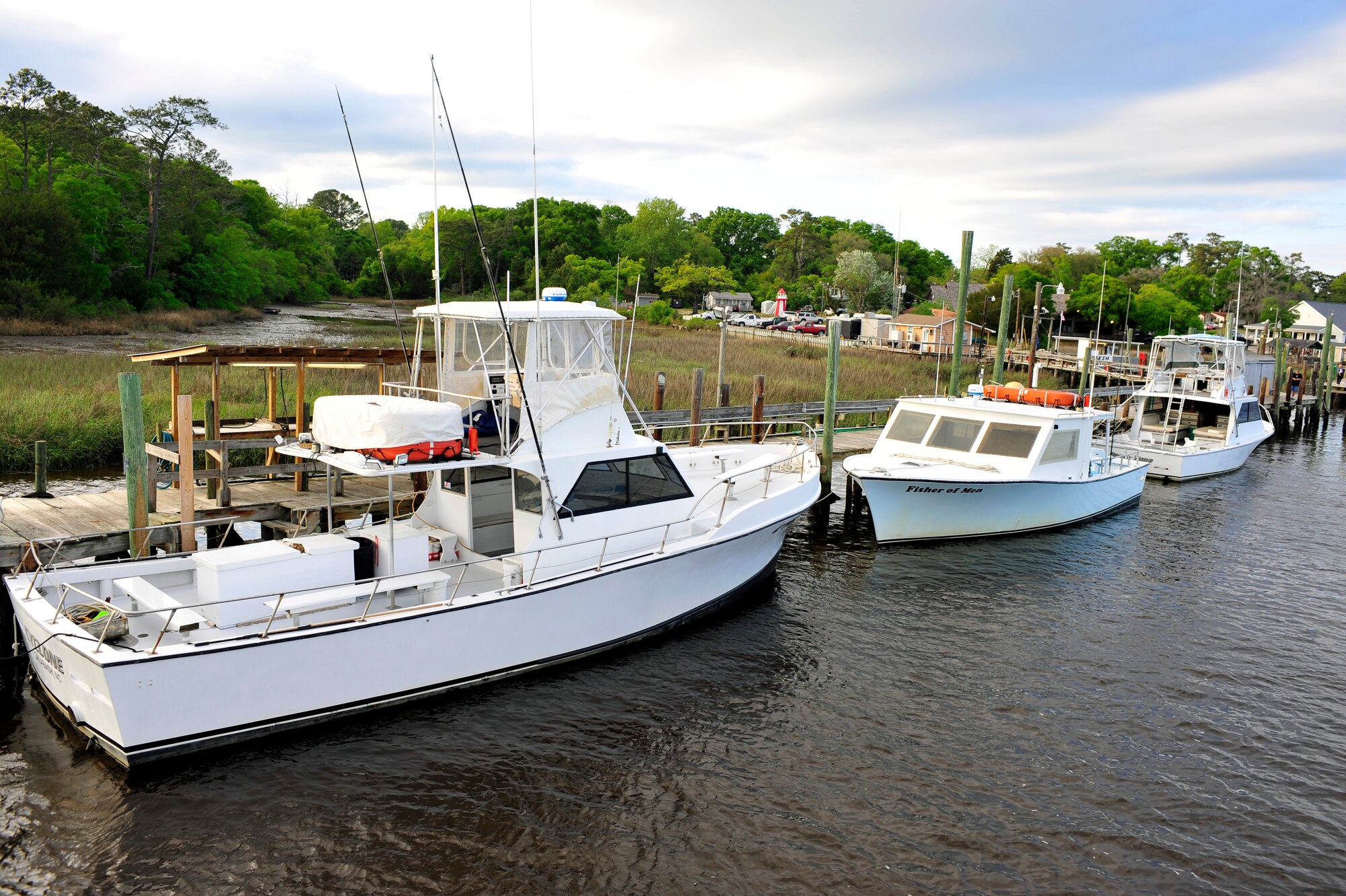 Three boats sit at a dock in a harbor of Calabash, N.C., April 14, 2012. Shaw’s outdoor recreation offers several deep sea fishing trips throughout the spring and summer that Department of Defense ID card holders can take advantage of. (U.S. Air Force photo by Senior Airman Daniel Phelps/Released)