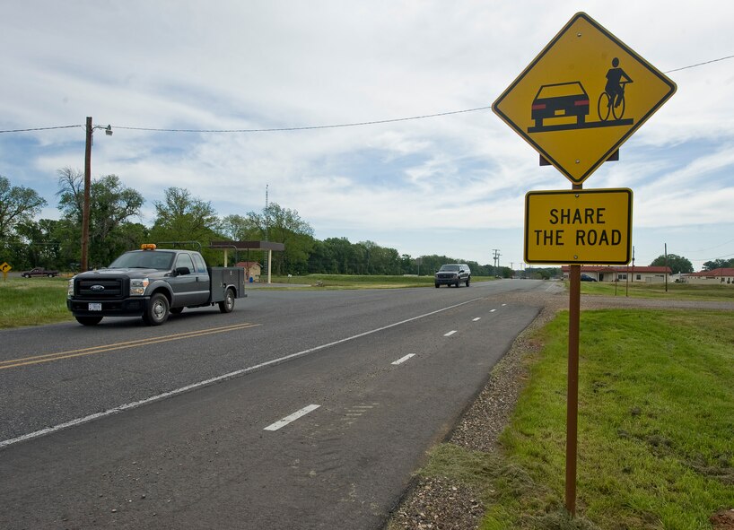 A sign reminds motorists and cyclists to be wary of each other at the intersection of Range Road and Crawfish Road on Barksdale Air Force Base, La. Beyond this point, Pike's Peak trail ends and cyclists merge back onto the road. (U.S. Air Force photo/Staff Sgt. Chad Warren)(RELEASED)