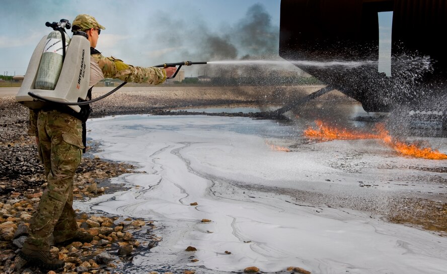 U.S. Air Force Capt. Michael Vins, 38th Rescue Squadron, Moody AFB, Ga. uses an Intelagard Macaw to extinguish a fire during training April 23, 2012, at Dyess Air Force Base, Texas. Dyess is one of five bases to use jet fuel for fire fighter training which provided pararescumen from Nellis AFB, Nev. and Moody the ideal emergency simulation. (U.S. Air Force photo by Airman 1st Class Jonathan Stefanko/ Released)