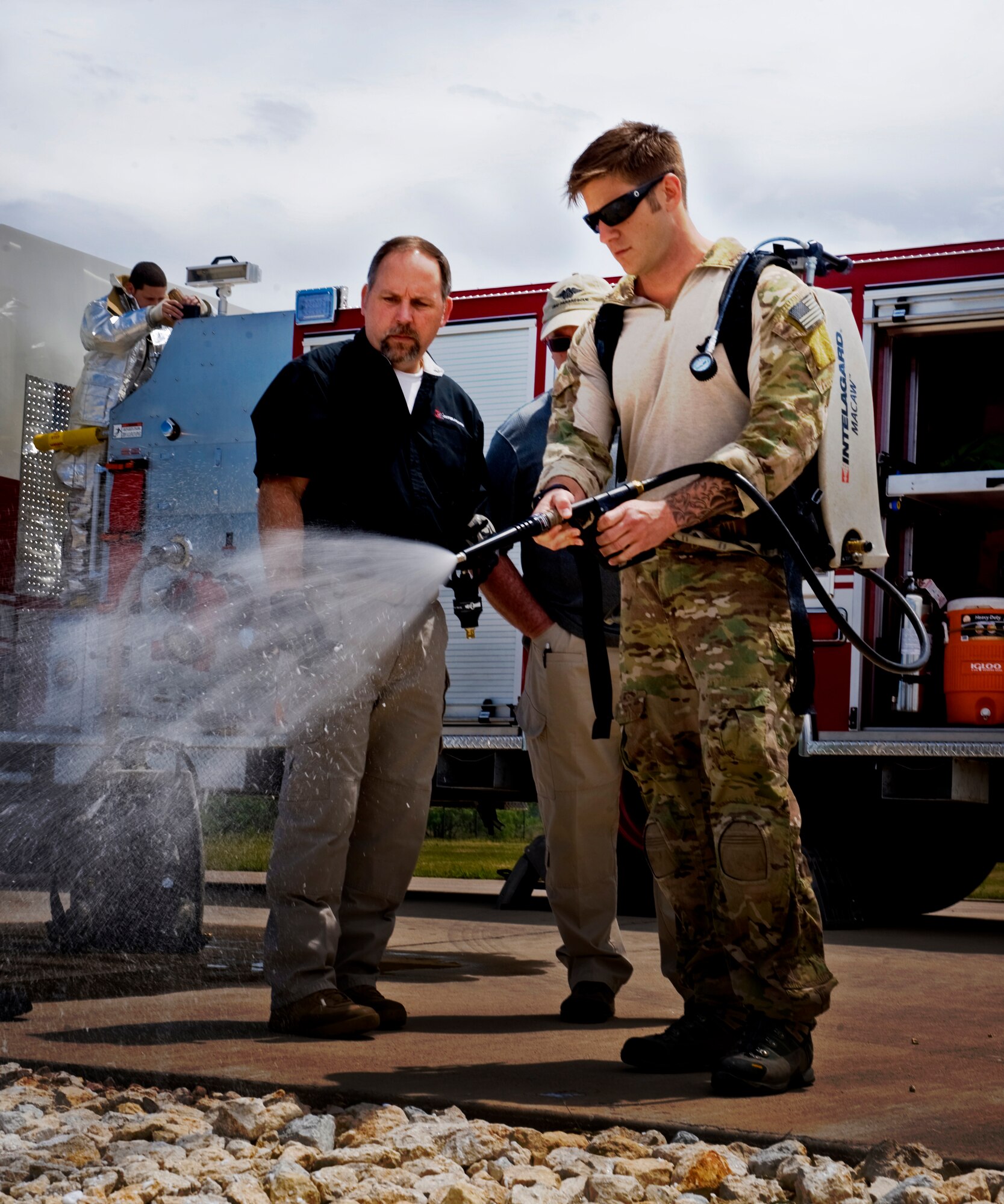 Senior Airman Adam Spataro, 58th Rescue Squadron, Nellis AFB, Nev. tests an Intelagard Macaw backpack during training April 23, 2012, at Dyess Air Force Base, Texas. Dyess is one of five bases to use jet fuel for fire fighter training, which provided pararescumen from Nellis and Moody AFB, Ga. the ideal emergency simulation. (U.S. Air Force photo by Airman 1st Class Jonathan Stefanko/Released)