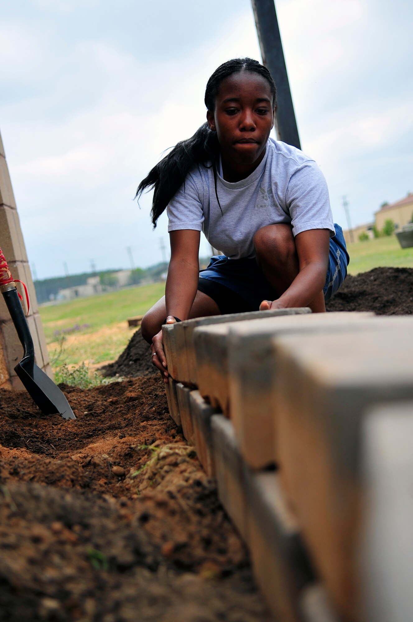 Airman 1st Class Angelica Gardner, 28th Operational Weather Squadron forecaster, lines up a brick for one of the garden plots to help beautify the area at Shaw Air Force Base, S.C., April 20, 2012. The 28th OWS decided to plant a garden in honor of the Air Force’s observance of Earth Day. The produce from their garden will later be used in a fall festival. (U.S. Air Force photo by Senior Airman Daniel Phelps/ Released)