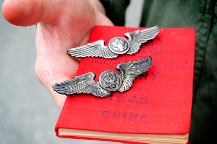 Staff Sgt. Matthew Skvarna holds his father's and grandfather's aircrew wings as well as his grandfather's World War II aircrew diary on Joint Base Charleston - Air Base, April 20. Skvarna is a third-generation aircrew member and carries these items with him on every mission. His father was a C-141 loadmaster and his grandfather was a right gunner on a B-29 Superfortress. His grandfather also received the Air Force Flying Cross for his efforts during the Pacific campaign during WWII. Skvarna is an instructor loadmaster with the 17th Airlift Squadron, 437th Airlift Wing. (U.S. Air Force Photo / Staff Sgt. Nicole Mickle)
