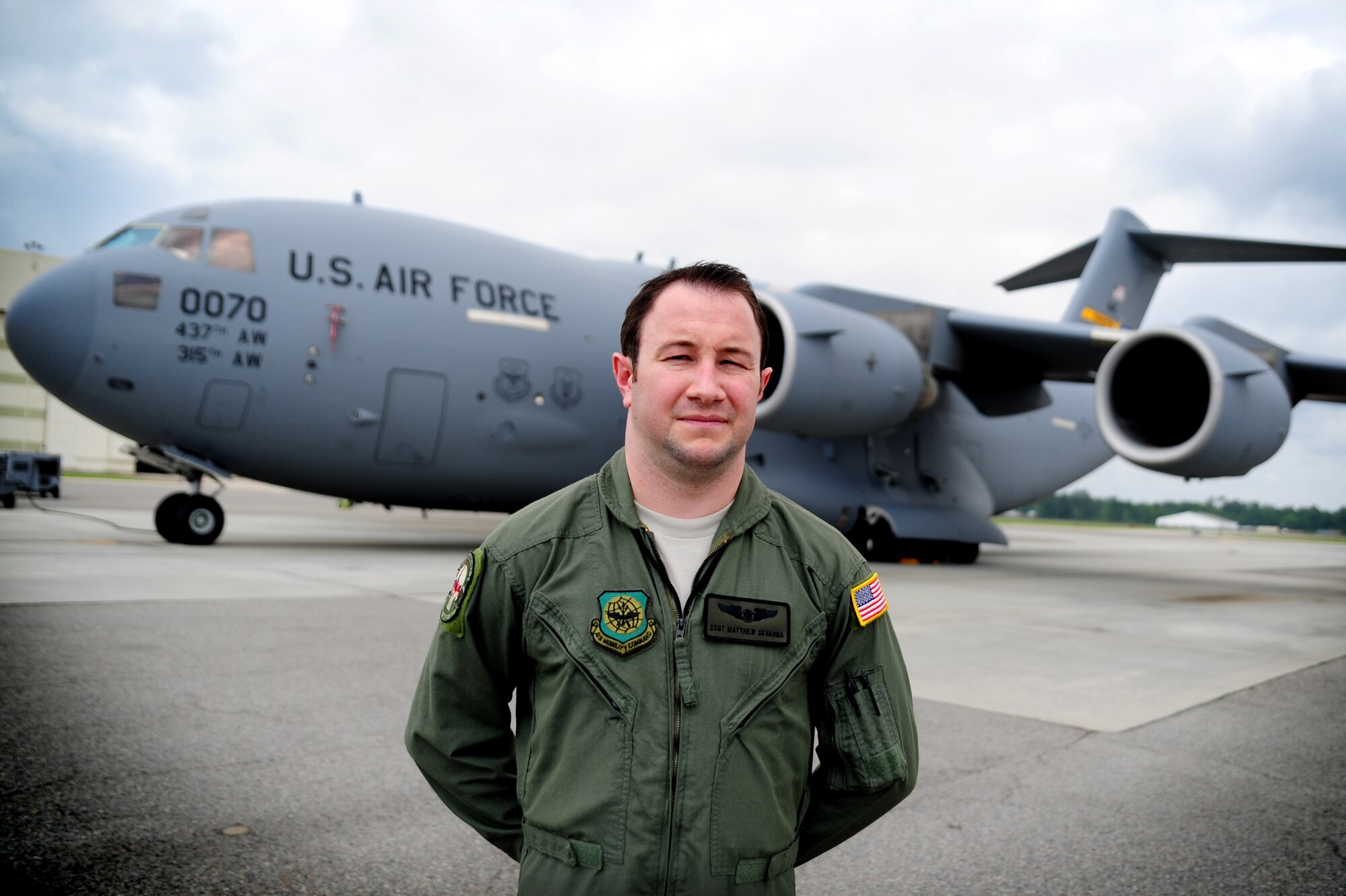 Staff Sgt. Matthew Skvarna stands in front of a C-17 Globemaster III on Joint Base Charleston - Air Base April 20. Skvarna is a third generation aircrew member. His father was a C-141 loadmaster and his grandfather was a right gunner on a B-29 Superfortress. His grandfather also received the Air Force Flying Cross for his efforts during the Pacific campaign during World War II. Skvarna is an instructor loadmaster with the 17th Airlift Squadron, 437th Airlift Wing. (U.S. Air Force Photo / Staff Sgt. Nicole Mickle)