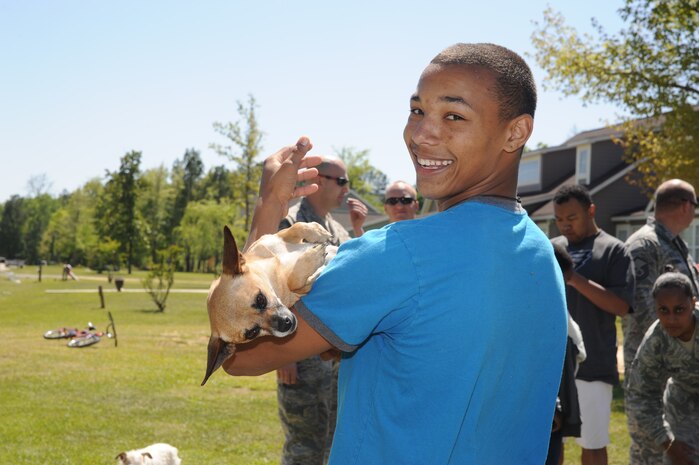 A resident plays with a dog at Eagle Harbor Ranch in Summerville, April 12. Airman from the 437th Maintenance Squadron Ammo Flight volunteer at Eagle Harbor Ranch at least four times a year. (U.S. Air Force photo/Airman 1st Class Chacarra Walker)
