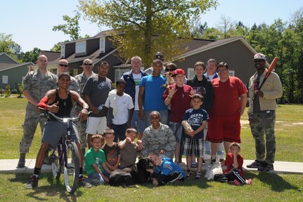 Joint Base Charleston Airmen and Eagle Harbor Ranch residents and owners pose for a photo at Eagle Harbor Ranch in Summerville, April 12.  Eagle Harbor Ranch is a place of refuge and shelter for children ages six to 21 who are orphaned, neglected, abused or abandoned. (U.S. Air Force photo/Airman 1st Class Chacarra Walker)