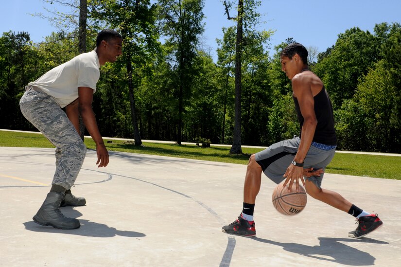 Airman 1st Class Arnold Stone-Patterson plays basketball with a young man at Eagle Harbor Ranch in Summerville April 12. Eagle Harbor Ranch is a place of refuge and shelter for children ages six to 21 who are orphaned, neglected, abused or abandoned. Stone-Patterson is from the 437th Maintenance Squadron Munitions Control. (U.S. Air Force photo/Airman 1st Class Chacarra Walker)