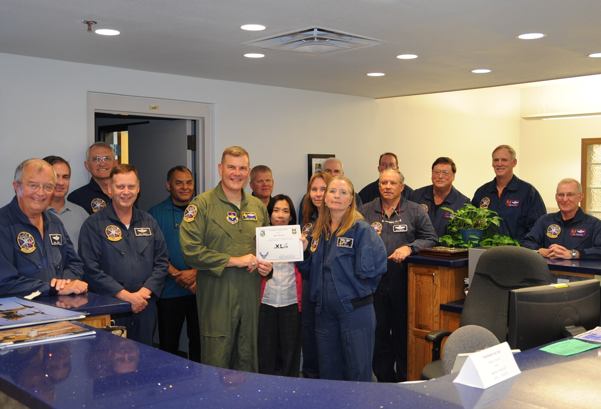 Jill Broyles, 47th Student Squadron simulator dispatcher, poses with Col. James Jinnette, 47th FTW vice commander, after being presented the XLer of the week award at Laughlin Air Force Base, Texas, April 18, 2012. The XLer is a weekly award chosen by wing leadership and given to those who consistently make outstanding contributions to Laughlin and their unit. (U.S. Air Force photo/Senior Airman Scott Saldukas)