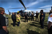 Dan Beatty (middle), Memorial Star Transport pilot, talks about the medevac helicopter capabilities during an exercise April 25 at Schriever Air Force Base. Emergency personnel including the fire department and the 50th Security Forces Squadron conducted an exercise to practice the base's medevac procedures. (U.S. Air Force photo/Staff Sgt. Julius Delos Reyes)