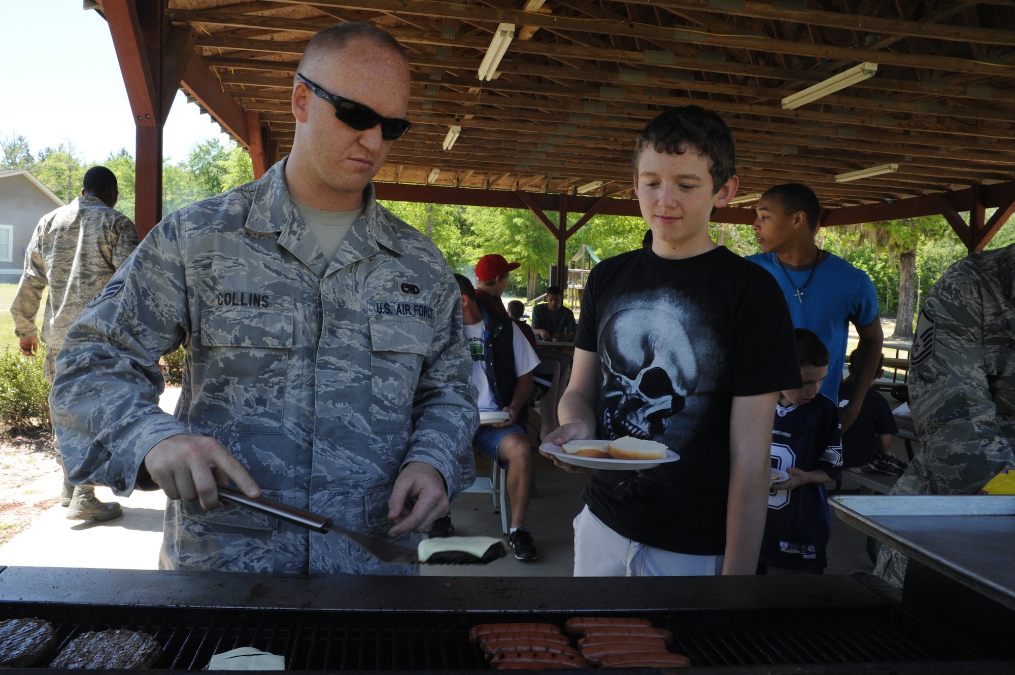 Senior Airman David Collins makes burgers and hot dogs at Eagle Harbor Ranch in Summerville April 12. The Eagle Harbor Ranch has been open since 2004. Collins is from the 437th Maintenance Squadron. (U.S. Air Force photo/Airman 1st Class Chacarra Walker)