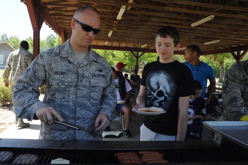 Senior Airman David Collins makes burgers and hot dogs at Eagle Harbor Ranch in Summerville April 12. The Eagle Harbor Ranch has been open since 2004. Collins is from the 437th Maintenance Squadron. (U.S. Air Force photo/Airman 1st Class Chacarra Walker)