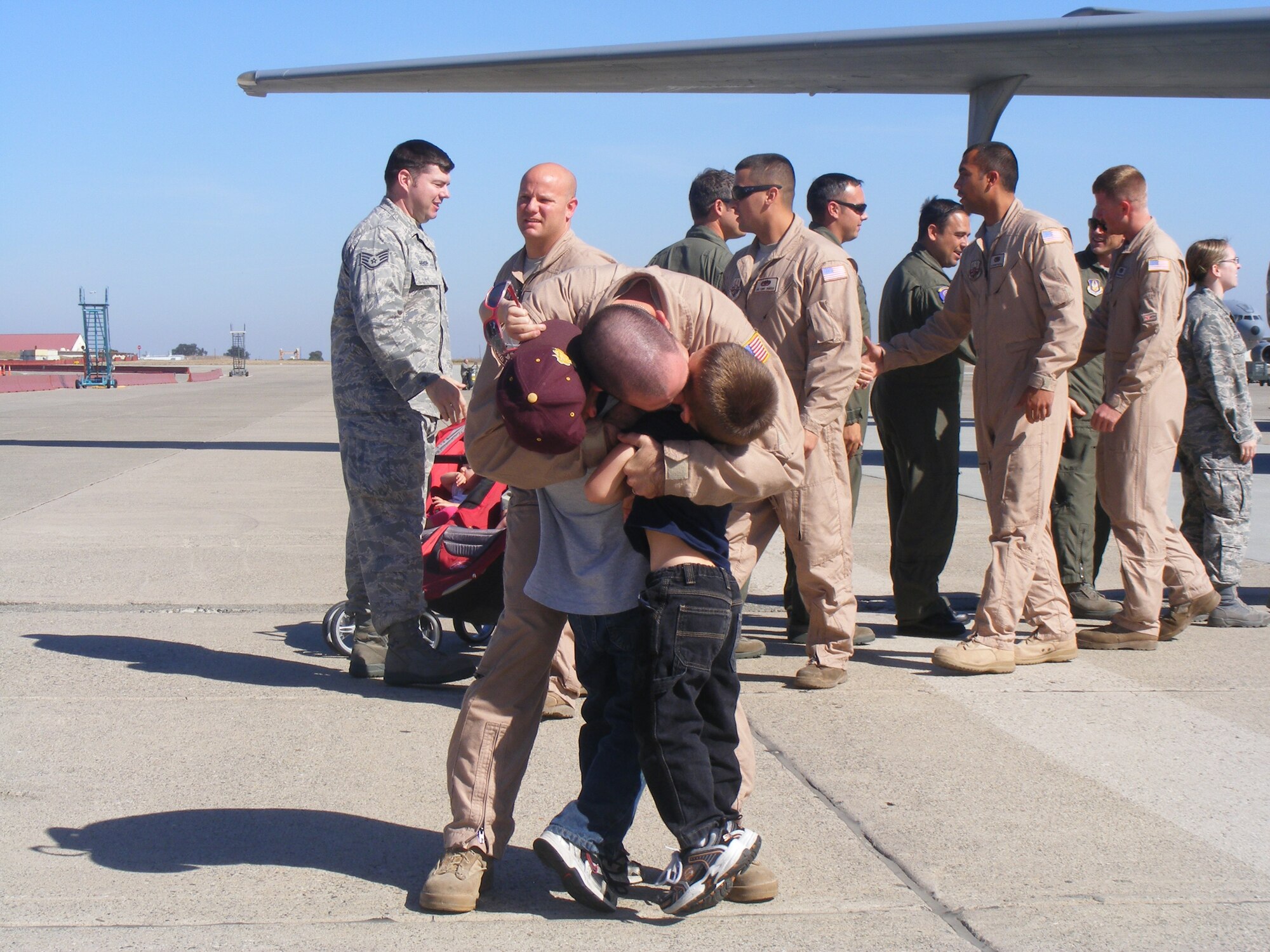 Senior Airman Jonathan Jackson, 6th Air Refueling Squadron KC-10 Extender
boom operator, hugs his children, Nolan and Thomas, after returning from
deployment. Nolan and Thomas are two of seven foster children Jackson has
fathered in his life along with his wife, Katie. 
