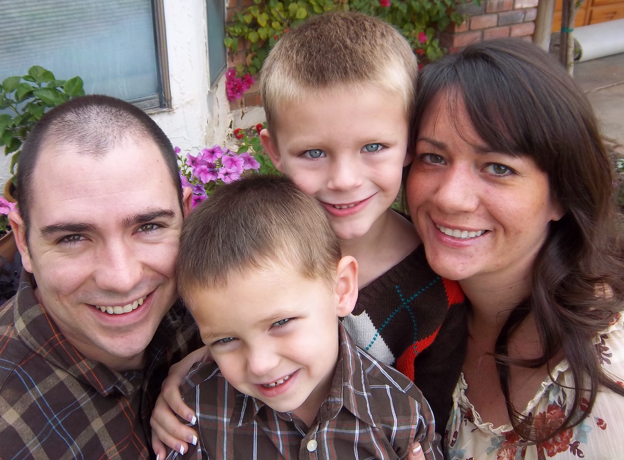 Senior Airman Jonathan Jackson, left, 6th Air Refueling Squadron KC-10
Extender boom operator, poses for a photograph with his children, Nolan and
Thomas, and his wife, Katie, at Thanksgiving in 2011. Jackson is nominated
for the National Fatherhood Initiative's Military Fatherhood Award for this
year. 
