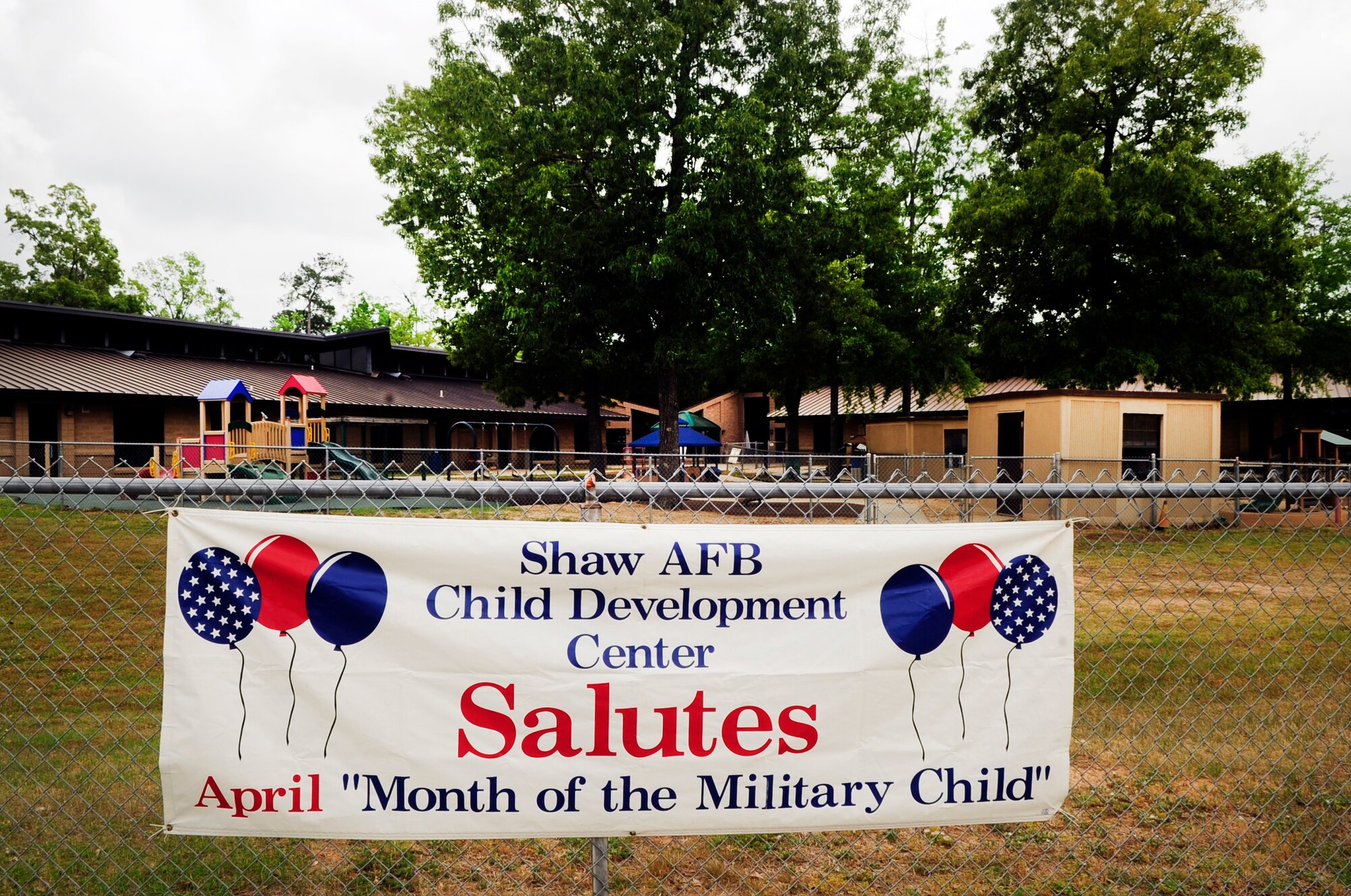 Child Development Center displays a banner outside the fence to show their support of the "Month of the Military Child" at Shaw Air Force Base, S.C., April 18, 2012. The month of April is the "Month of the Military Child." During this month, numerous events are held for children to recognize the sacrifices of children in military families. (U.S. Air Force photo by Airman 1st Class Hunter Brady/released)