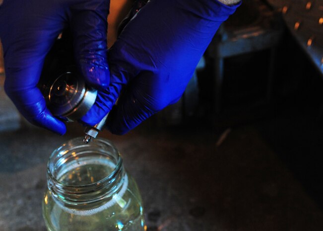 Airman 1st Class Mark Miller samples fuels at Joint Base Charleston – Air Base April 24. Fuels are sampled and tested daily. Miller is a 628 Logistics Readiness Squadron fuels laboratory. (U.S. Air Force photo/Staff Sgt. Katie Gieratz) (Released)