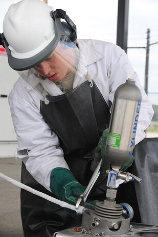 Staff Sgt. Jonathon Kloessel secures the issue hose coupler prior to liquid oxygen testing at Joint Base Charleston - Air Base April 23. The liquid oxygen tanks are tested for contaminants every 90 days and provide oxygen directly to pilots. Kloessel is a 628th Logistics Readiness Squadron fuels laboratory technician.  (U.S. Air Force photo/Staff Sgt. Katie Gieratz) (Released)