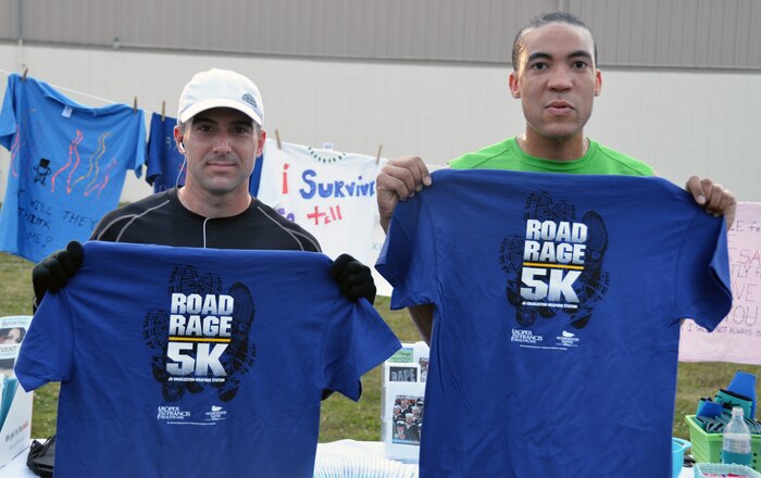 Navy Lt. Chris Lebel and Petty Officer 2nd Class Dennis Nunez display their T-shirts after completing the second annual Sexual Assault Awareness 5k-Run at Sam's Gym at Joint Base Charleston - Weapons Station April 25. Lebel came in first place with a time of 19:43. Nunez came in second with a time of 21:02. Lebel is assigned to the Naval Consolidated Brig - Charleston and Nunez is a hospital corpsman at the Naval Health Clinic. The run was sponsored by the JB Charleston - Weapons Station Sexual Assault Response Coordination office in observance of April being Sexual Assault Awareness Month. (U.S. Air Force Photo / Airman 1st Class Tom Brading)