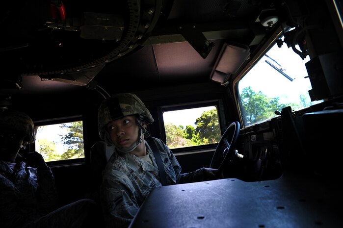 Airman 1st Class Angela Sell checks with her team before driving a High-Mobility Multipurpose Wheeled Vehicle during tactical vehicle training at Joint Base Charleston - Air Base April 24. The monthly training is given to members of the 628th Security Forces Squadron to familiarize them with operating tactical vehicles and how to perform security checks while in a convoy.  Sell is a 628th SFS journeyman.    (U.S. Air Force photo/ Staff Sgt. Nicole Mickle)   