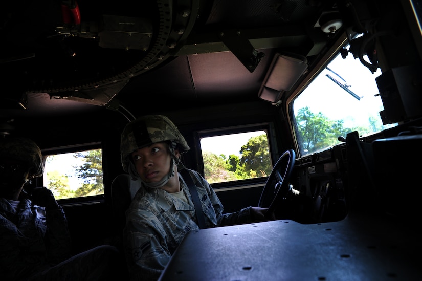 Airman 1st Class Angela Sell checks with her team before driving a High-Mobility Multipurpose Wheeled Vehicle during tactical vehicle training at Joint Base Charleston - Air Base April 24. The monthly training is given to members of the 628th Security Forces Squadron to familiarize them with operating tactical vehicles and how to perform security checks while in a convoy.  Sell is a 628th SFS journeyman.    (U.S. Air Force photo/ Staff Sgt. Nicole Mickle)   