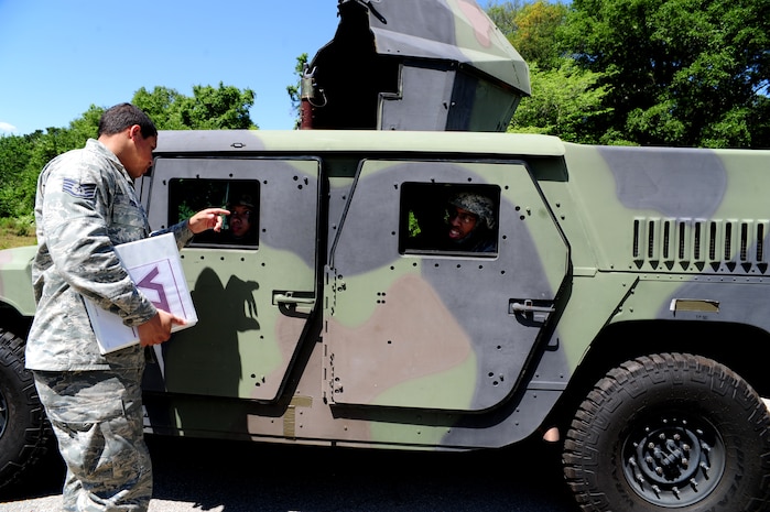 Staff Sgt. David Perez explains procedures on how to replace a downed driver in a High-Mobility Multipurpose Wheeled Vehicle during tactical vehicle training at Joint Base Charleston - Air Base April 24. The monthly training is given to members of the 628th Security Forces Squadron to familiarize them with operating tactical vehicles and how to perform security checks while in a convoy.  Perez is a 628th SFS trainer.  (U.S. Air Force photo/ Staff Sgt. Nicole Mickle)