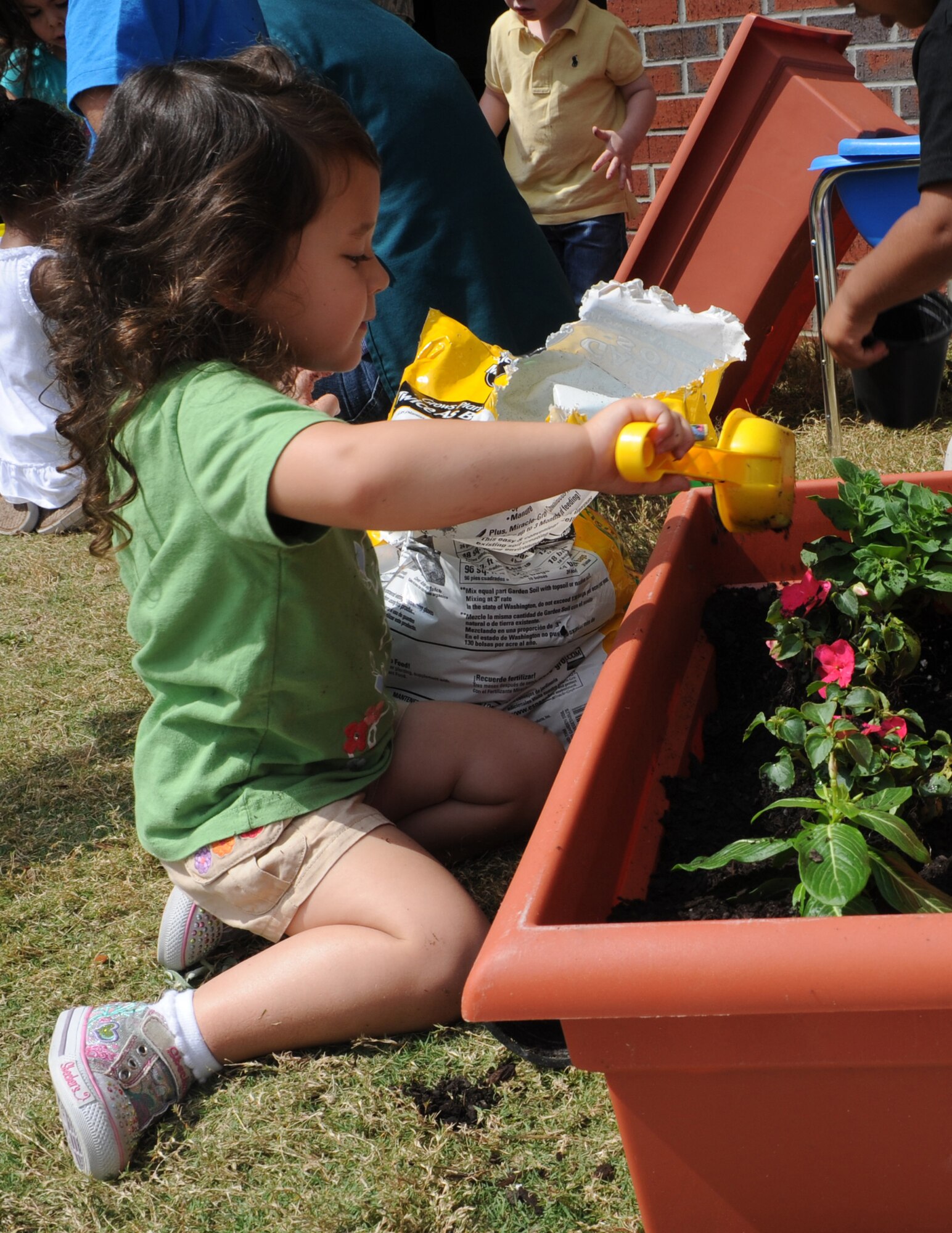 Makayla Parker plants a flower during the Joint Base Charleston - Air Base's event Child Development Center's Gardening with Parents April 20. Makayla’s father is Tech. Sgt. Marcus Parker, 437th Maintenance Operations Squadron. (U.S. Air Force photo/Airman 1st Class Chacarra Walker)
