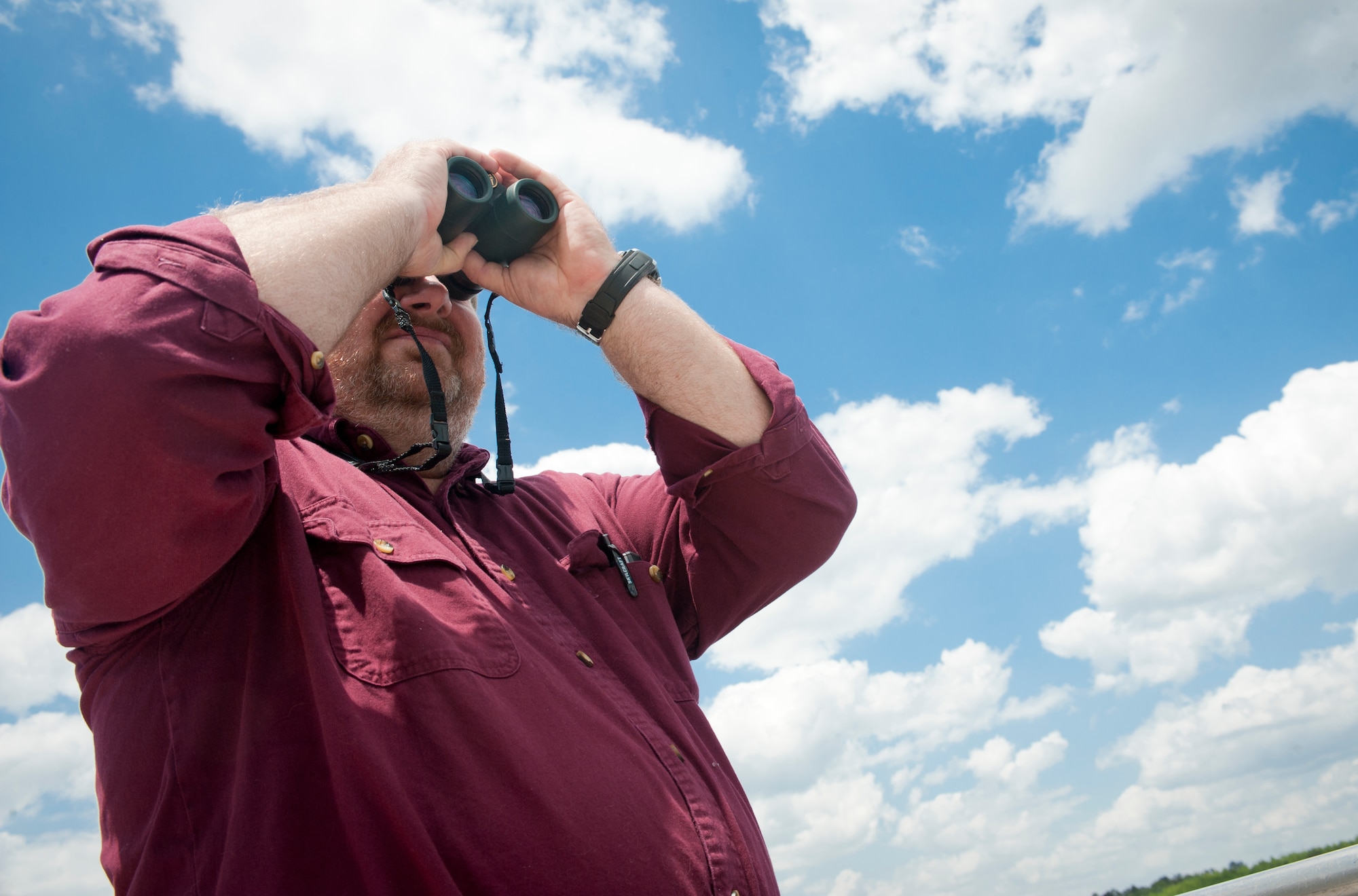 Gregory Lee, 23d Civil Engineer Squadron environmental management chief, uses binoculars to look for alligators at Mission Lake on Moody Air Force Base, Ga., April 17, 2012. Lee visits Mission Lake daily to monitor the alligators and keep track of the ones that may have lost their fear of humans. (U.S. Air Force photo by Airman 1st Class Jarrod Grammel/Released)
