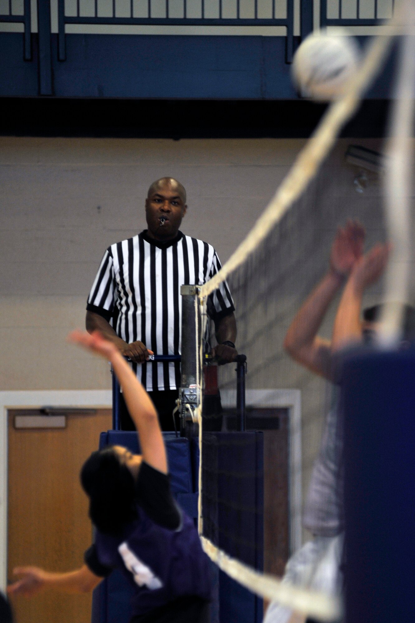 Johnny Lockhart, a volleyball official, calls the intramural volleyball game between the 19th Force Support Squadron and the 19th Medical Group, April 24, 2012, at Little Rock Air Force Base, Ark. Lockhart will be officiating more than six games this season. (U.S. Air Force photo by Airman 1st Class Rusty Frank)