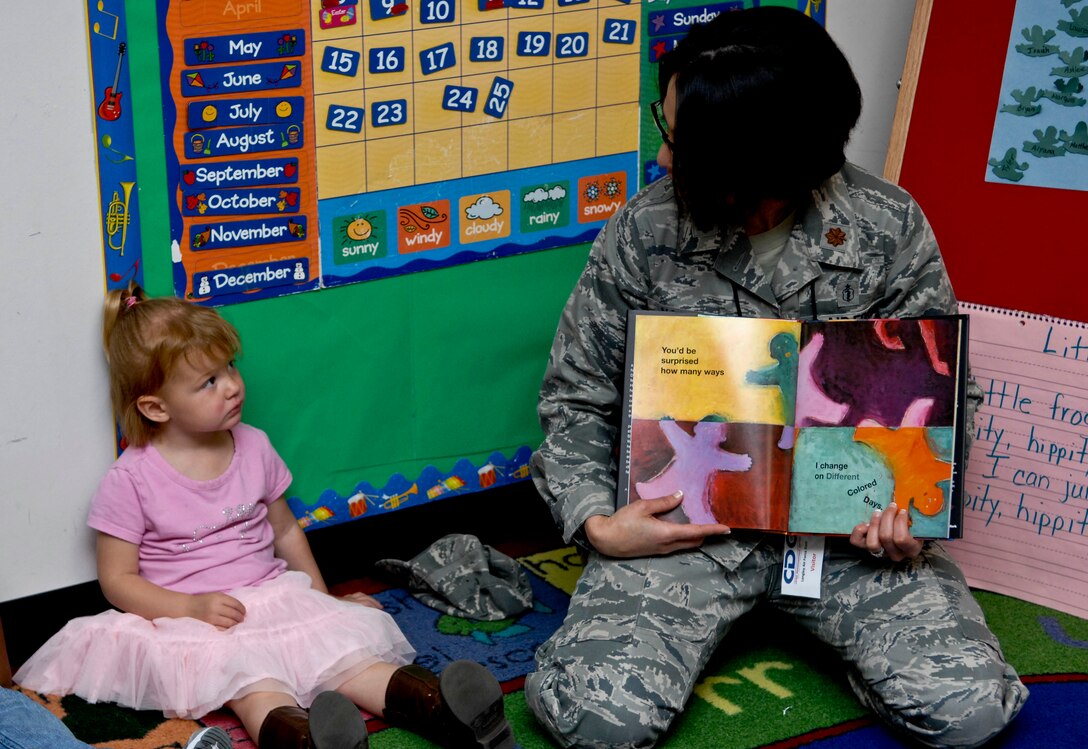U.S. Air Force Maj. Elizabeth Najera, 633rd Medical Operations Squadron behavioral health flight commander, reads the book “My Many Colored Days,” by Dr. Suess as 3-year-old Alexis Taylor listens carefully during “Read to Kids Day,” at Langley Air Force Base, Va.,  Apr. 25, 2012. Read to Kids Day was sponsored by the Langley Family Advocacy office. (U.S. Air Force photo by Senior Airman Wesley Farnsworth)