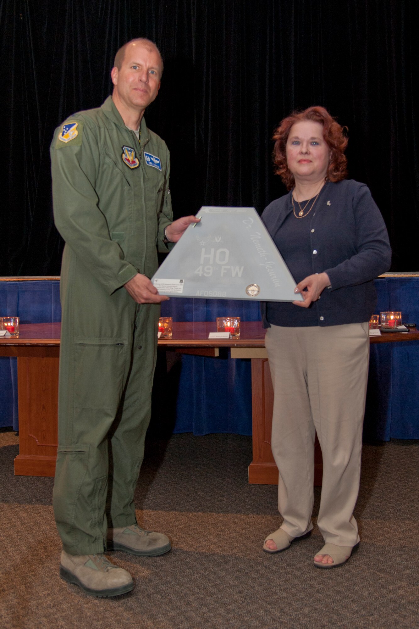 HOLLOMAN AIR FORCE BASE, N.M. – Col. Kenneth Johnson, 49th Wing vice commander, presents Dr. Nancy Nemeth-Jesurun, a University of Texas at El Paso graduate of Border History studies, with a plaque April 19 at the Community Activity Center. Nemeth-Jesurun came to speak to members of Team Holloman during the nation’s annual “Days of Remembrance,” which honors victims of the Holocaust. (U.S. Air Force photo by Airman 1st Class Anthony M. Ward / Released)