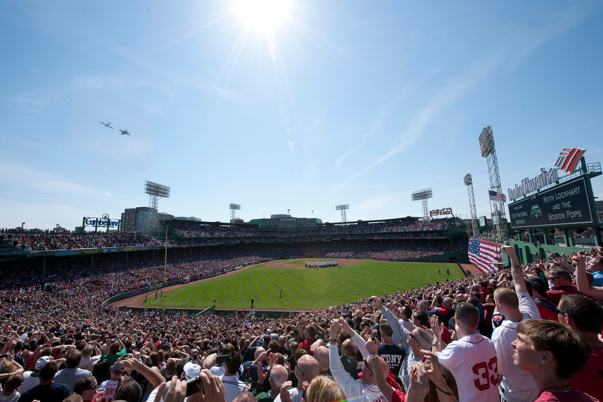 BOSTON – To the delight of fans, an F-16 and P-51 fly over Fenway Park at the end of the national anthem April 20. The flyover, featuring modern and World War II-era aircraft, was part of the 100th anniversary of Fenway Park celebration. (U.S. Air Force photo by Walter Santos)