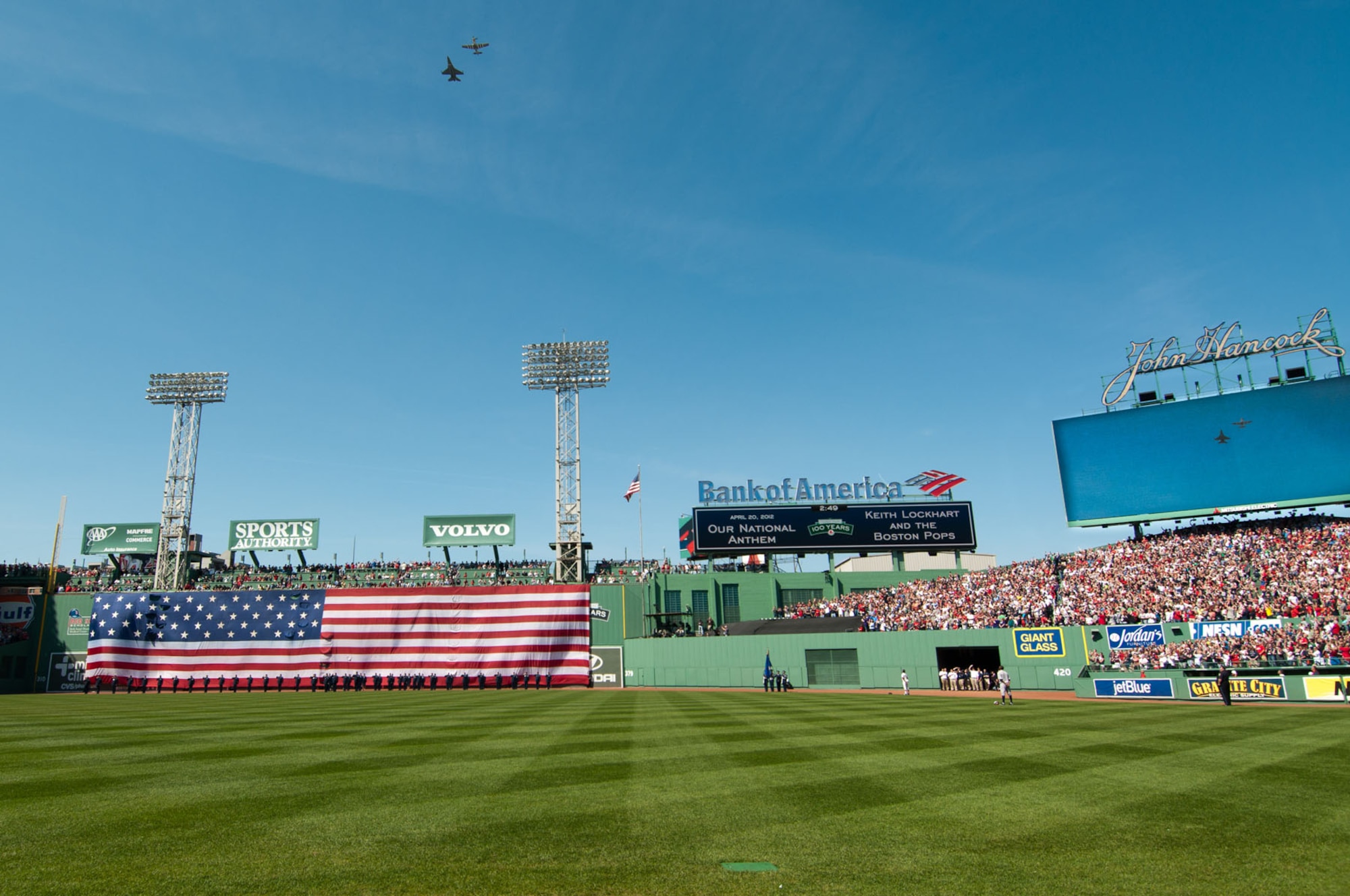 BOSTON – An F-16 and P-51 fly over Fenway Park during the playing of the national anthem April 20. The flyover, featuring modern and World War II-era aircraft, was part of the 100th anniversary of Fenway Park celebration. (U.S. Air Force photo by Rick Berry)