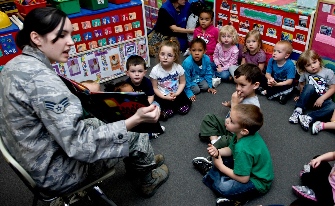 Children listen as U.S. Air Force Senior Airman Sarah Shoemaker , 633rd Medical Operations Squadron mental health technician, reads to them at the Langley Air Force Base, Va., Child Development Center as part of “Read to Kids Day,” Apr. 25, 2012. More than 50 children were read to by three volunteers from Langley AFB. (U.S. Air Force photo by Senior Airman Wesley Farnsworth)