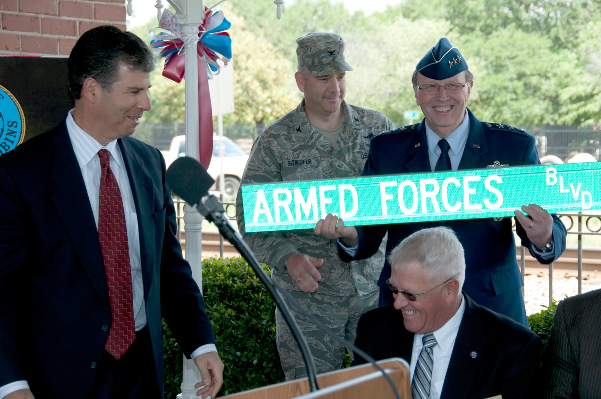 Warner Robins Mayor Chuck Shaheen presents the Armed Forces Boulevard street sign to Lt. Gen. Charles E. Stenner, commander of Air Force Reserve Command, and Col. Mitchel Butikofer, 78th Air Base Wing commander, during the street renaming ceremony April 24. The city renamed North First Street in honor of the men and women of the armed forces at Robins Air Force Base. (U.S. Air Force photo/Staff Sgt. Alexi Saltekoff)