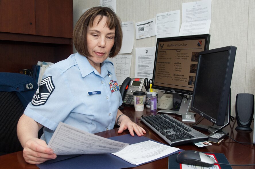 HANSCOM AIR FORCE BASE, Mass. – Chief Master Sgt. Cindy Rainey, 66th Medical Squadron superintendent, looks over paperwork in her office April 9. Chief Rainey said that although Sexual Assault Awareness Month is almost over, the Air Force’s focus on this important issue will continue. (U.S. Air Force photo by Rick Berry)