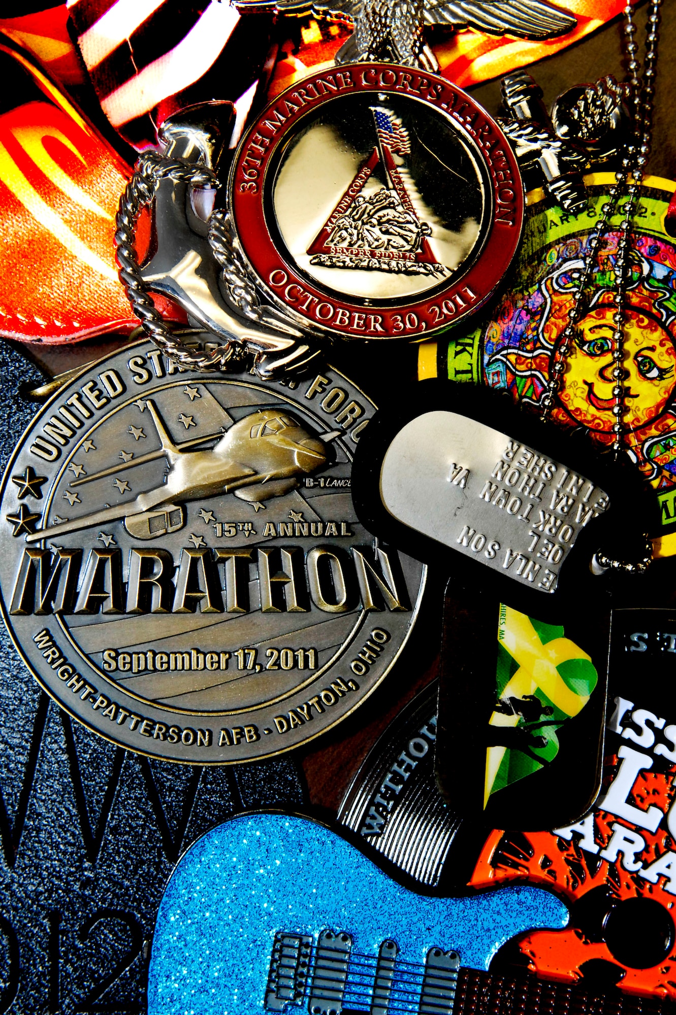 Medals from various marathons belonging to U.S. Air Force Maj. Joel Fenlason, Air Combat Command Contingency and Readiness Branch chief, represent the more than 20 marathons he completed last year.Fenlason is part of the running group Marathon Maniacs, a club made up of people who all share the love for running. (U.S. Air Force illustration by Senior Airman Wesley Farnsworth)