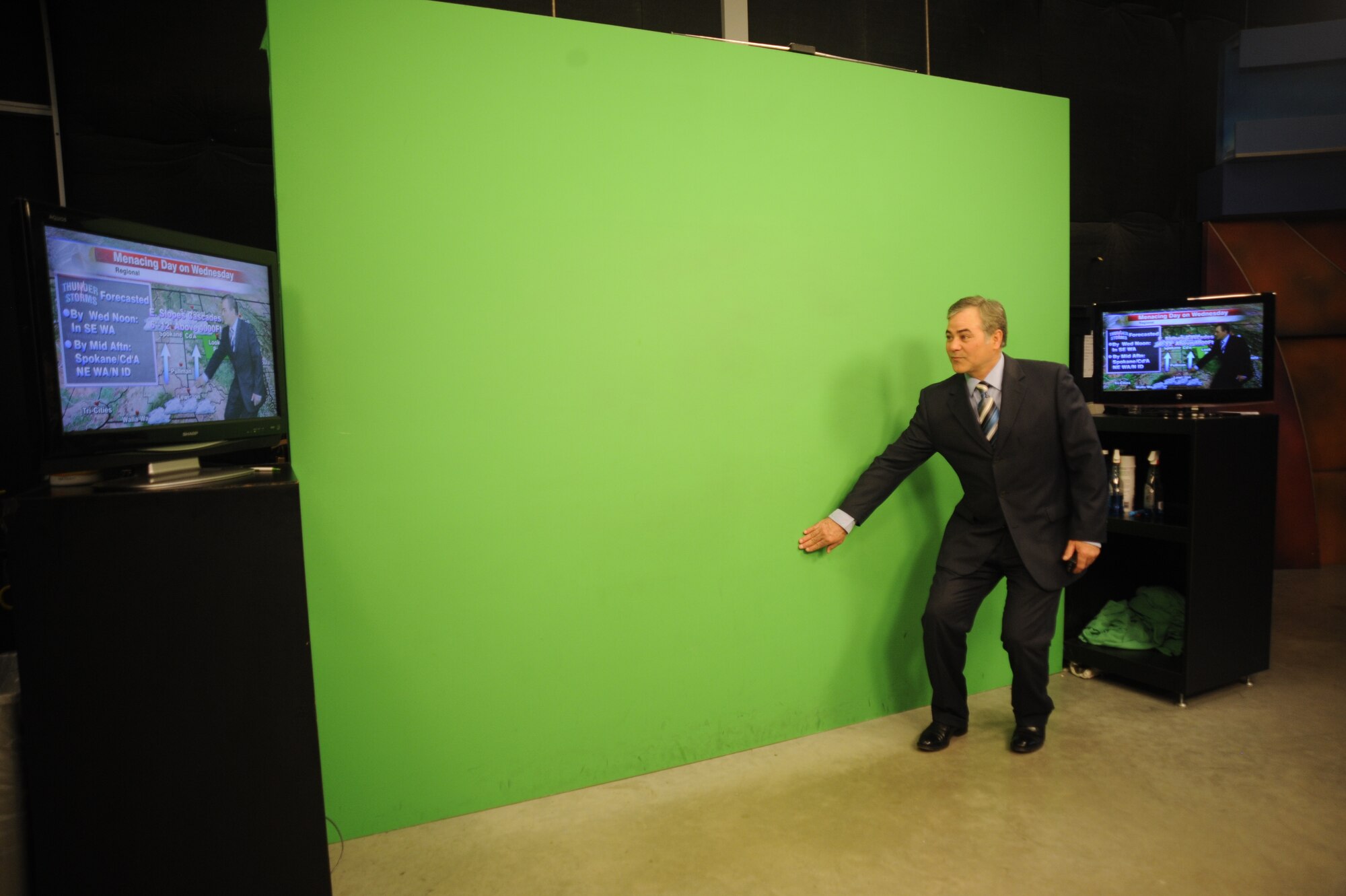 KHQ 6 News meteorologist Dave Law demonstrates how he does the weather in Spokane, Wash., April 12, 2012. He stands in front of a green screen with two monitors on each side to help him show viewers weather information. KHQ 6 anchors often use scripts to deliver news, meteorologists deliver the forecasts “off the cuff” without the use of a script. (U.S. Air Force photo by Airman 1st Class Earlandez Young/Released)