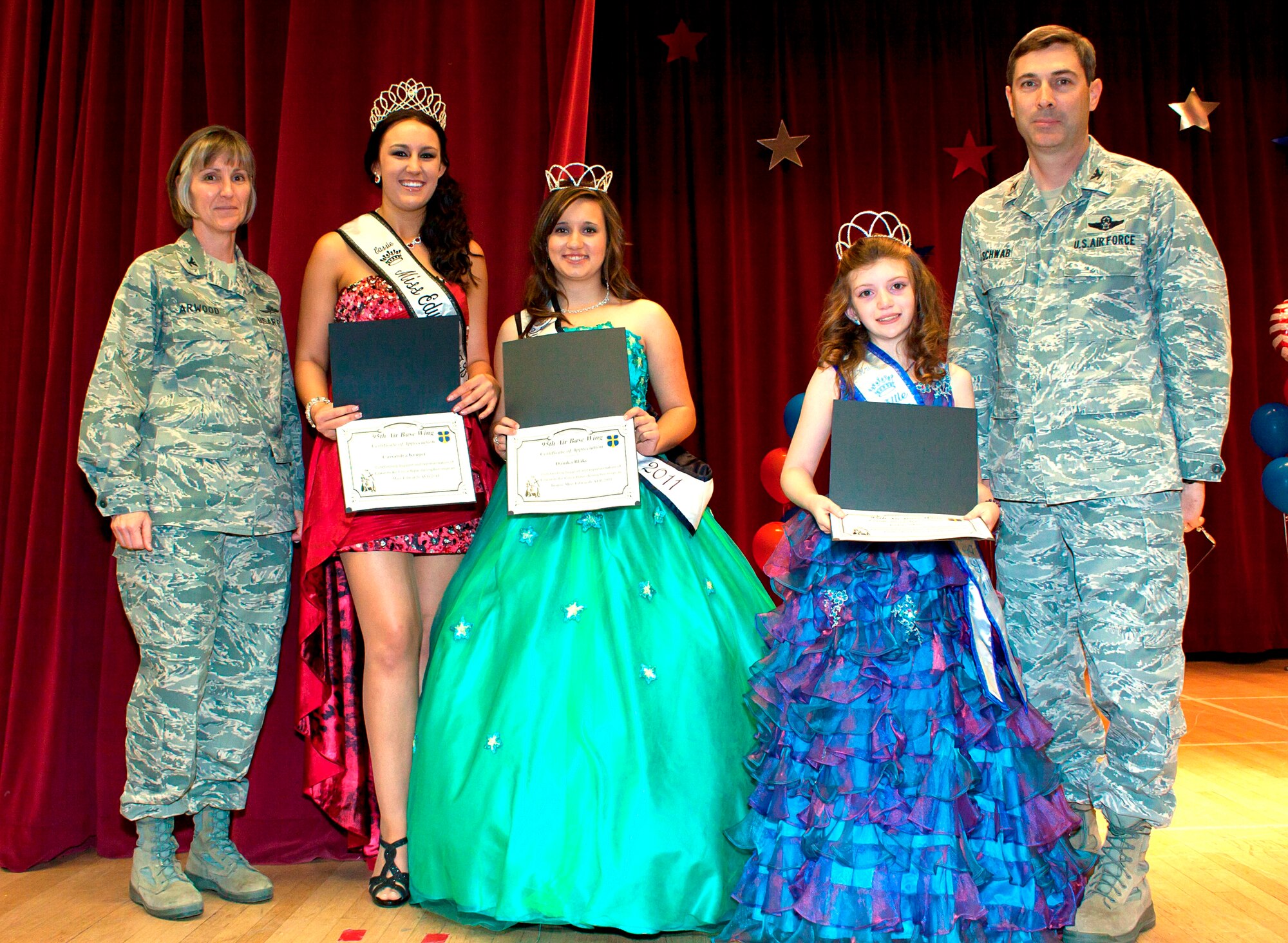 Col. Gregory Schwab, 95th Air Base Wing commander (far right), poses for a photo with the outgoing Edwards Community Queens along with Col. Amy Arwood, 95th ABW vice commander. The outgoing queens were presented with certificates of appreciation. The outgoing queens are from left to right: Cassandra Kruger, Miss Edwards; Danika Blake, Junior Miss Edwards; and Little Miss Edwards, Kristy Mace. (Courtesy photos)