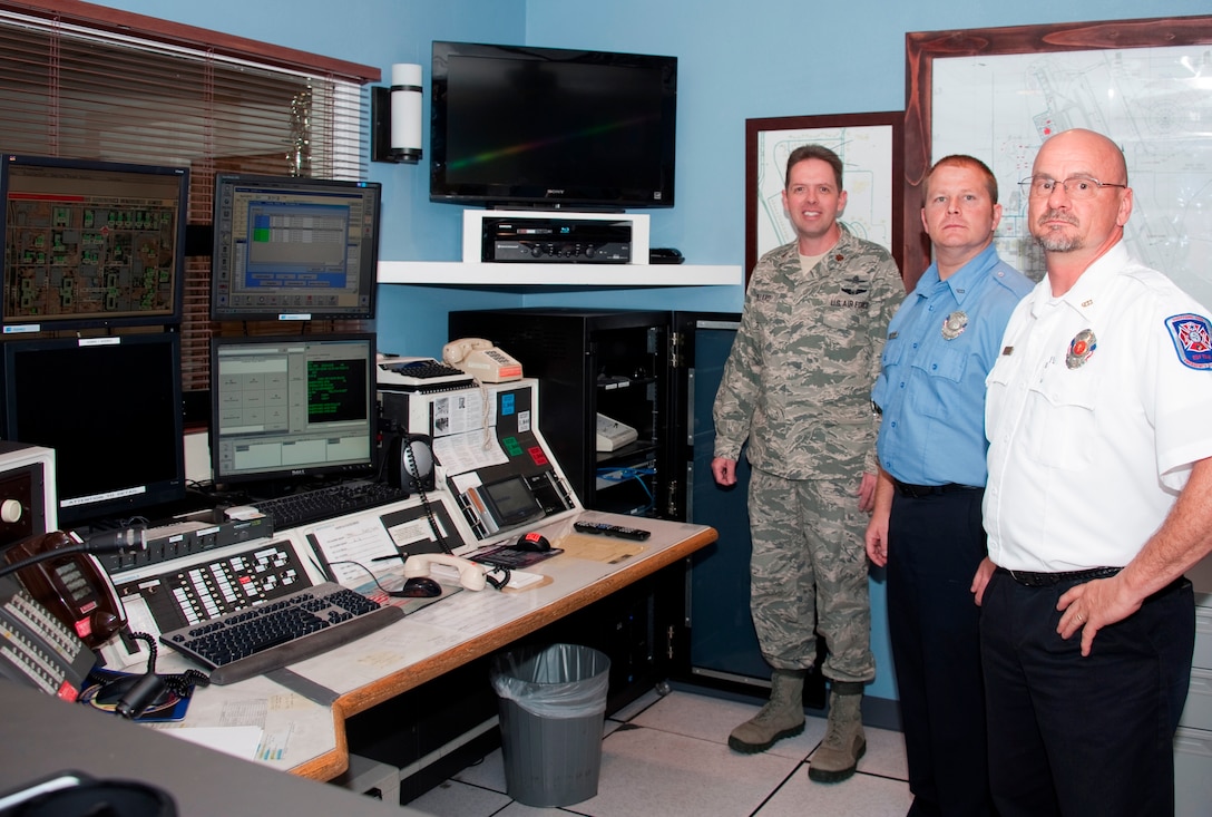 Maj. Wade Dillard (left), 82nd Communications Squadron commander, stands in the Emergency Communications Center (ECC) with dispatcher Mark Krotzer (center) and ECC supervisor Richard Chamberlain of the 82nd Civil Engineering Squadron's Fire Department April 23, 2012.  The ECC revamped the 9-1-1 emergency phone system with a computer-based system to pinpoint callers exact locations and one-touch conference calling with different response agencies, speeding up response times in emergency situations. (U.S. Air Force photo/Danny Webb)