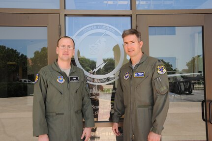 Second Lt. Davy Braxton (left) and his commander, Lt. Col. Bryan Runkle, stand outside the squadron headquarters April 17 at Joint Base San Antonio-Randolph. (U.S. Air Force photo/Rich McFadden) 