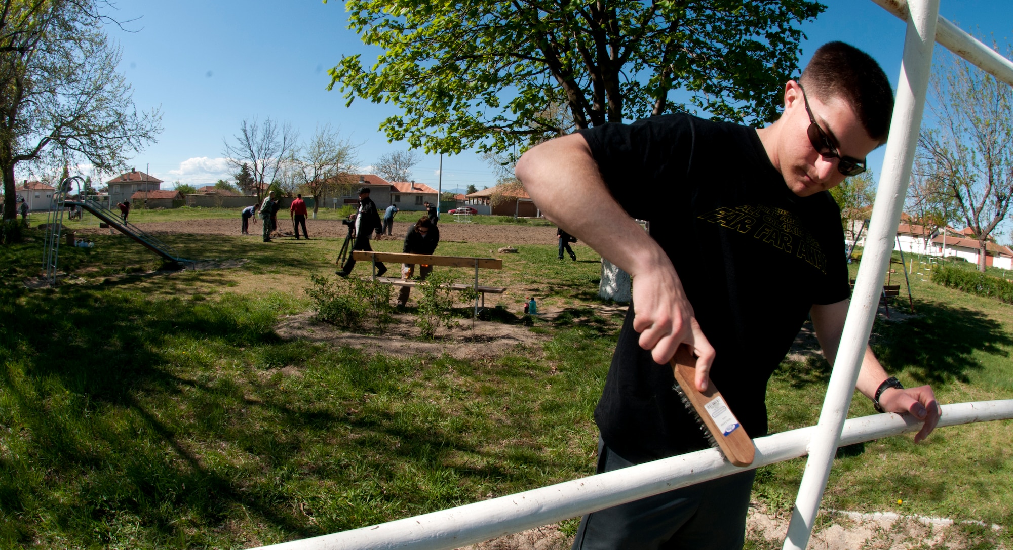 Second Lt. Bryan Humphries, 31st Maintenance Squadron, cleans playground equipment at a park in Graf Ignatievo, Bulgaria April 22, 2012. More than 150 U.S. and Bulgarian air force members volunteered their off-duty time to refurbish playground equipment and build a soccer field at a village park. U.S. Air Force members are deployed from the 31st Fighter Wing at Aviano Air Base, Italy, to Graf Ignatievo Air Force Base to participate in Thracian Star 2012, a coalition training exercise geared towards strengthening partnerships and improving interoperability between NATO allies. (U.S. Air Force photo/Senior Airman Katherine Windish)