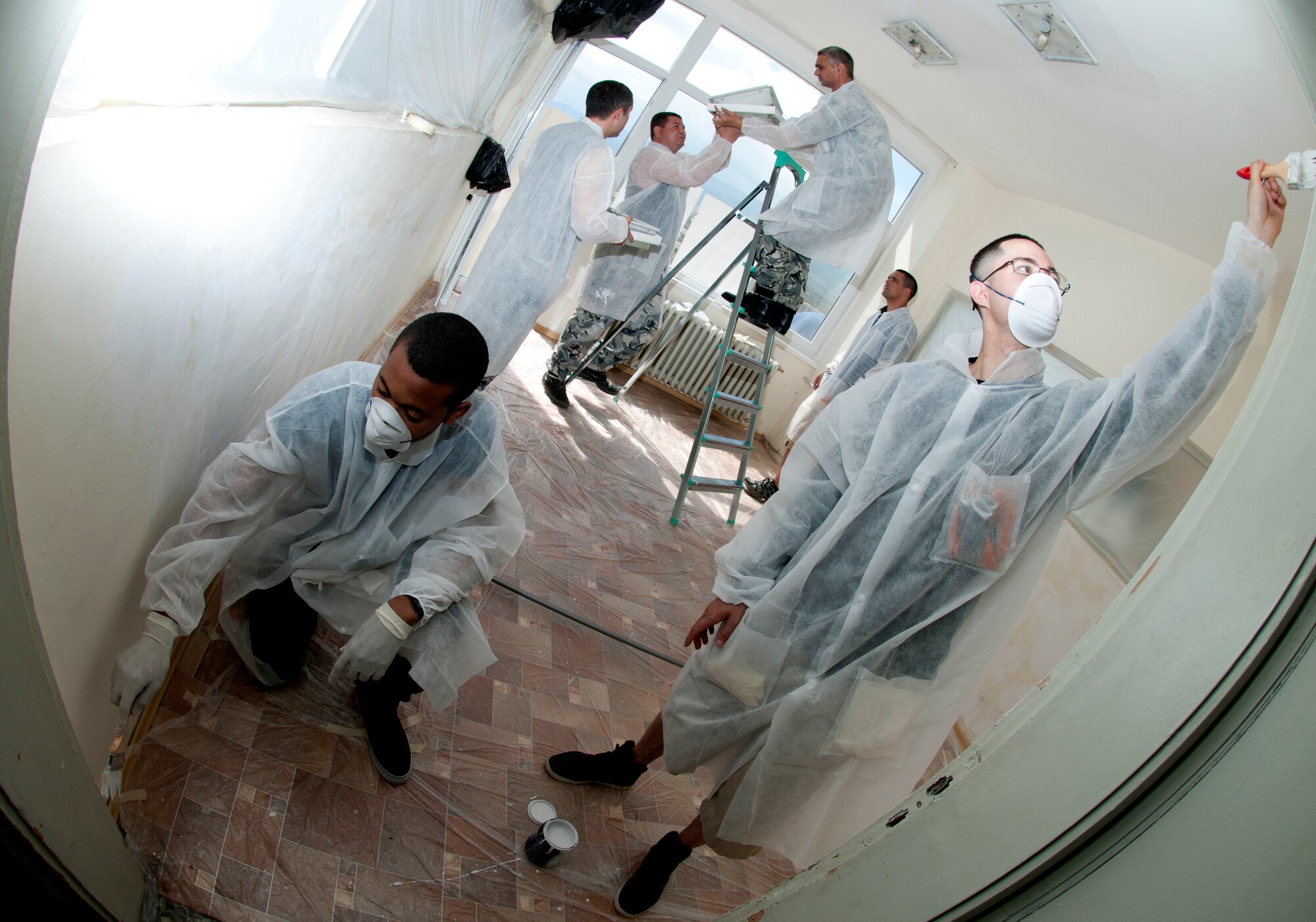 Airmen 1st Class Ron Arcino and Demario Reid, (front), paint a door frame in St. George's University pediatric surgery ward April 21, 2012, in Plovdiv, Bulgaria. More than 60 U.S. and Bulgarian air force members volunteered to renovate the children's ward during their off-duty time from the Thracian Star 2012 exercise being conducted at Graf Ignatievo Air Force Base. The volunteers cleaned, painted and decorated 11 post-operation rooms in the wing. Both Arcino, an ammo technician with the 31st Aircraft Maintenance Squadron, and Reid, a support equipment maintenance crew chief for the 31st Munitions Squadron, are based out of Aviano Air Base, Italy. (U.S. Air Force photo/Senior Airman Katherine Windish)