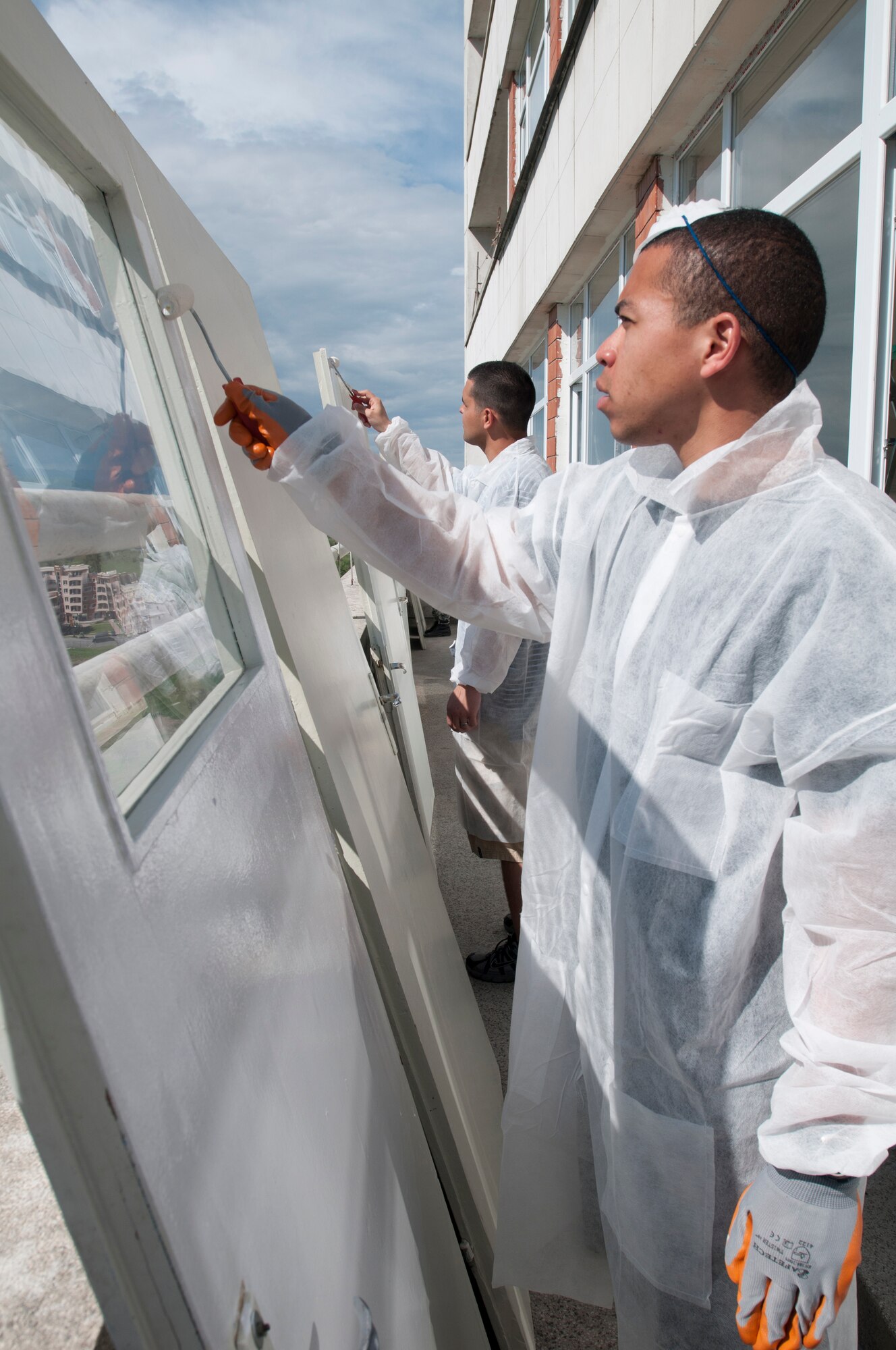 Staff Sgt. John Tapper, (front), 31st Logistics Readiness Squadron vehicle maintainer from Aviano Air Base, Italy, paints a door in the St. George's University pediatric surgery ward April 21, 2012, in Plovdiv, Bulgaria. More than 60 U.S. and Bulgarian air force members volunteered to renovate the children's ward during their off-duty time from the Thracian Star 2012 exercise being conducted at Graf Ignatievo Air Force Base. The volunteers spent two days cleaning, painting and decorating 11 rooms in the ward. (U.S. Air Force photo/Senior Airman Katherine Windish) 