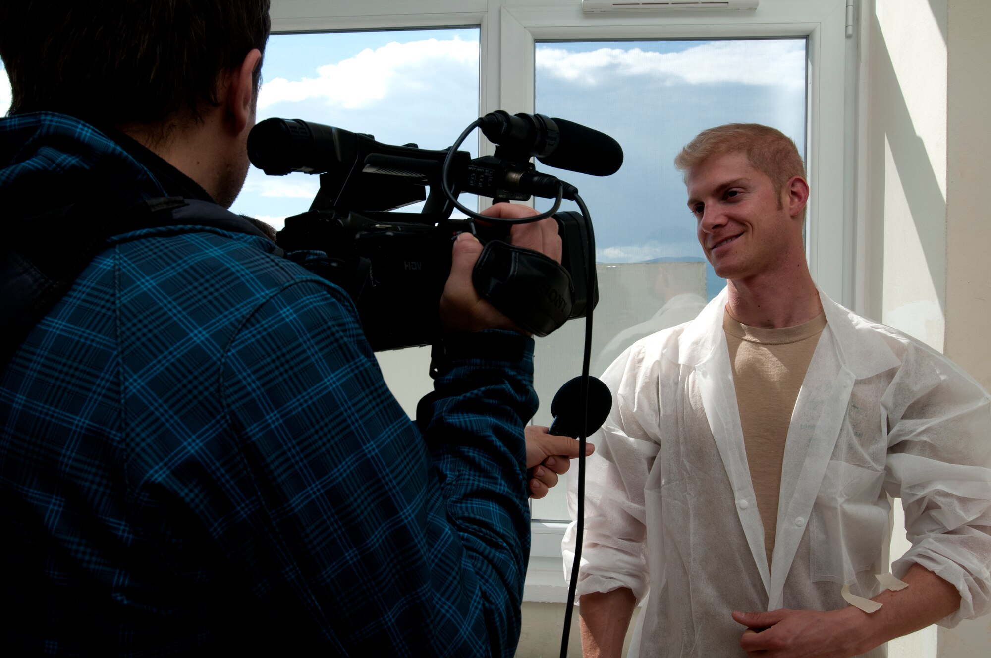 Capt. Mike Slotten, 510th Fighter Squadron F-16 Fighting Falcon pilot, is interviewed by Bulgarian media while volunteering at St. George's University April 21, 2012, in Plovdiv, Bulgaria. U.S. Air Force members are deployed to Graf Ignatievo Air Force Base, Bulgaria to participate in a coalition training exercise geared towards strengthening partnerships with NATO allies. More than 60 U.S. and Bulgarian Air Force members spent two days cleaning, painting and decorating 11 post-operation rooms in the pediatric surgery ward. (U.S. Air Force photo/Senior Airman Katherine Windish)
