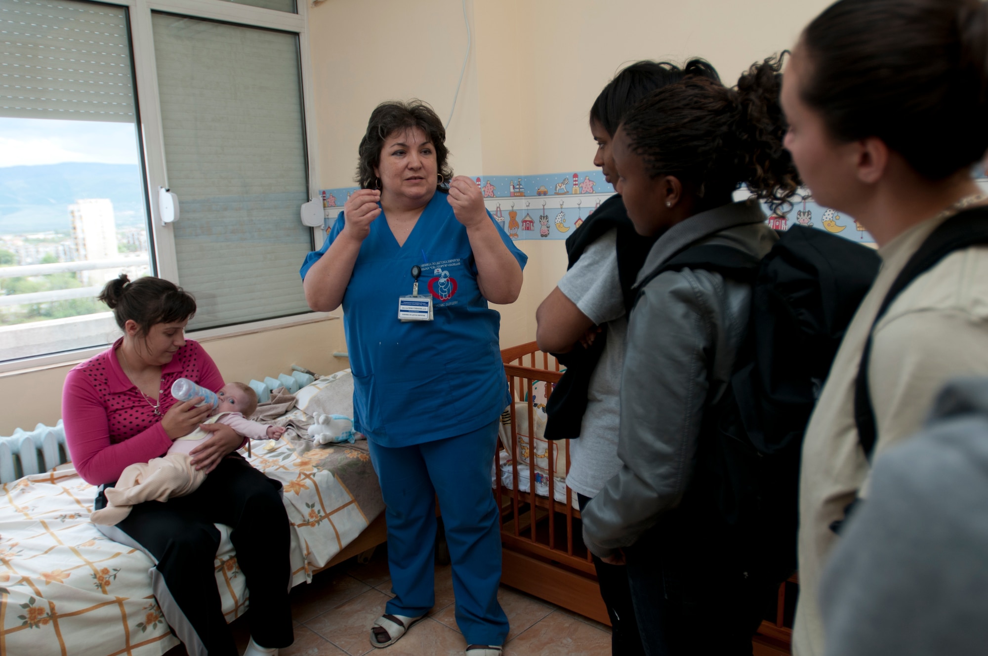 Doctor Margarita Stefanova, St. George's University chief pediatric surgeon, introduces volunteers to one of the pediatric department patients in appreciation for renovating part of the hospital's pediatric wing April 22, 2012, in Plovdiv, Bulgaria. U.S. Air Force members are deployed from the 31st Fighter Wing at Aviano Air Base, Italy, to Graf Ignatievo Air Force Base in support of Thracian Star 2012, a bilateral coalition training exercise geared towards strengthening partnerships and improving interoperability between NATO allies. More than 60 U.S. and Bulgarian Air Force members spent two days cleaning, painting and decorating 11 post-operation rooms in the pediatric surgery ward. (U.S. Air Force photo/Senior Airman Katherine Windish)